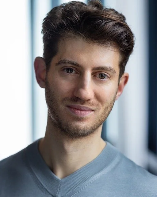 Headshot of Richard Bermange in a blue-grey t-shirt.