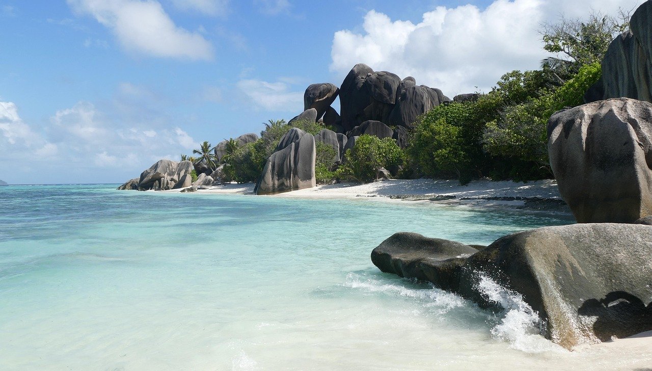 Smooth granite boulders frame a pristine Seychelles beach