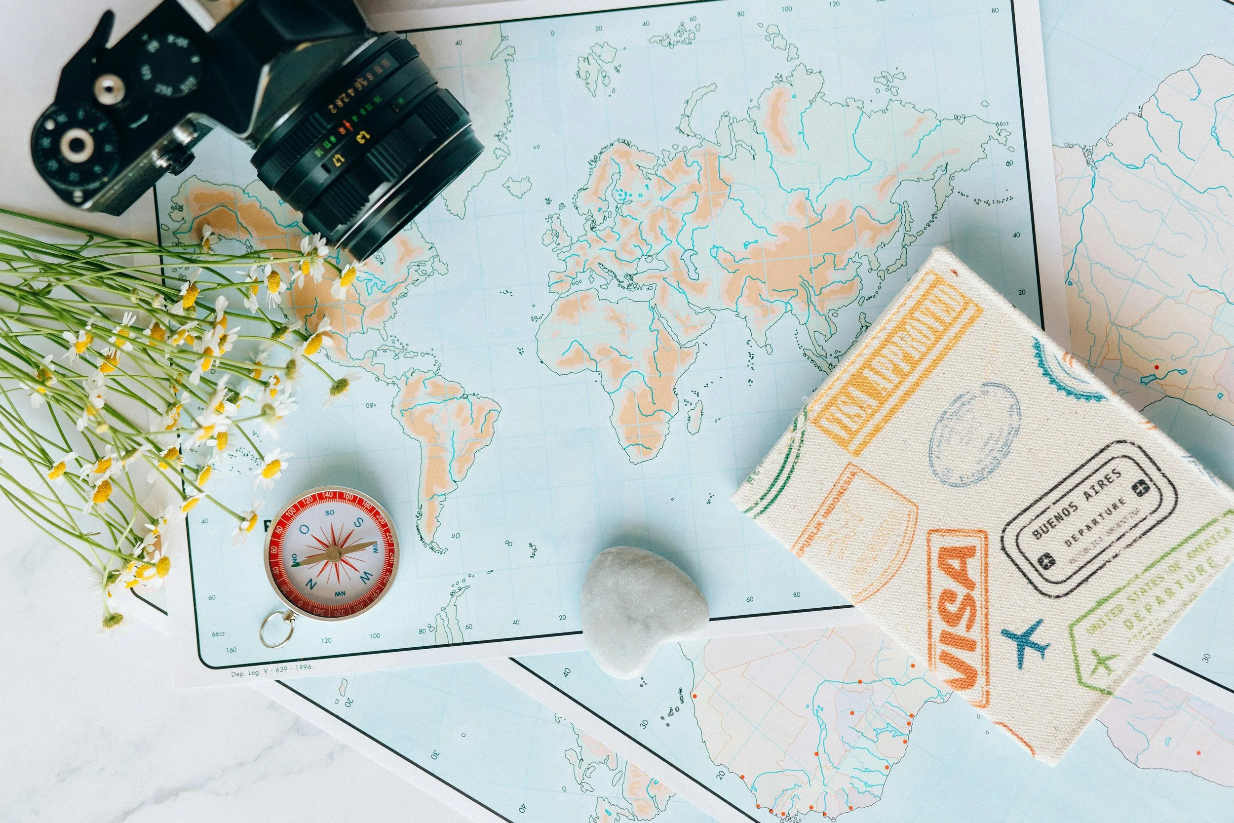 Travel map with binoculars and visas used for planning an international safari trip