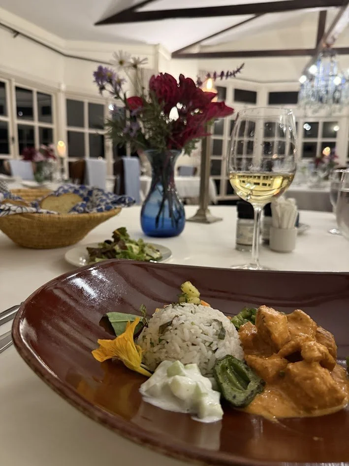 Plate of gourmet food served at luxury safari lodge, showcasing African-inspired cuisine and fresh ingredients