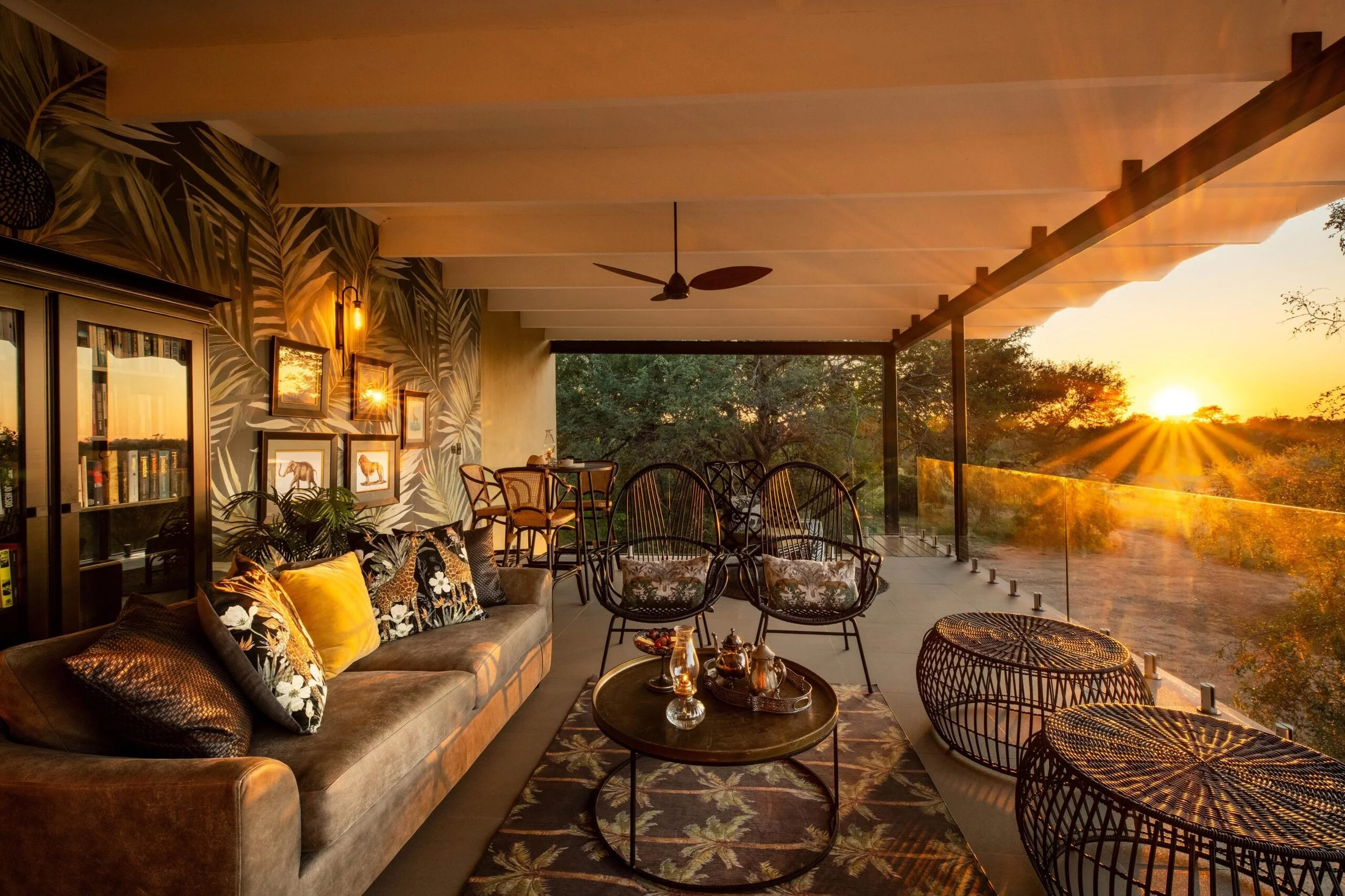 Luxury safari camp observation lounge with panoramic sunset views over the African plains