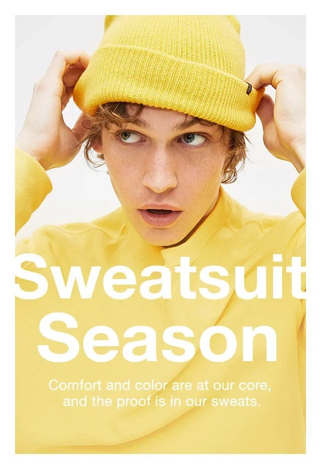 Young man wearing a yellow beanie and yellow sweatshirt, adjusting his hat, with text that reads 'Sweatsuit Season' and a tagline about comfort and color.