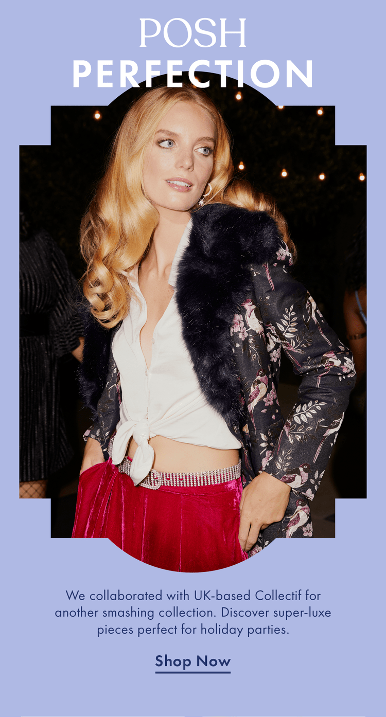 A woman with long blonde hair wearing a floral blazer and red velvet pants, standing at a party with string lights in the background.