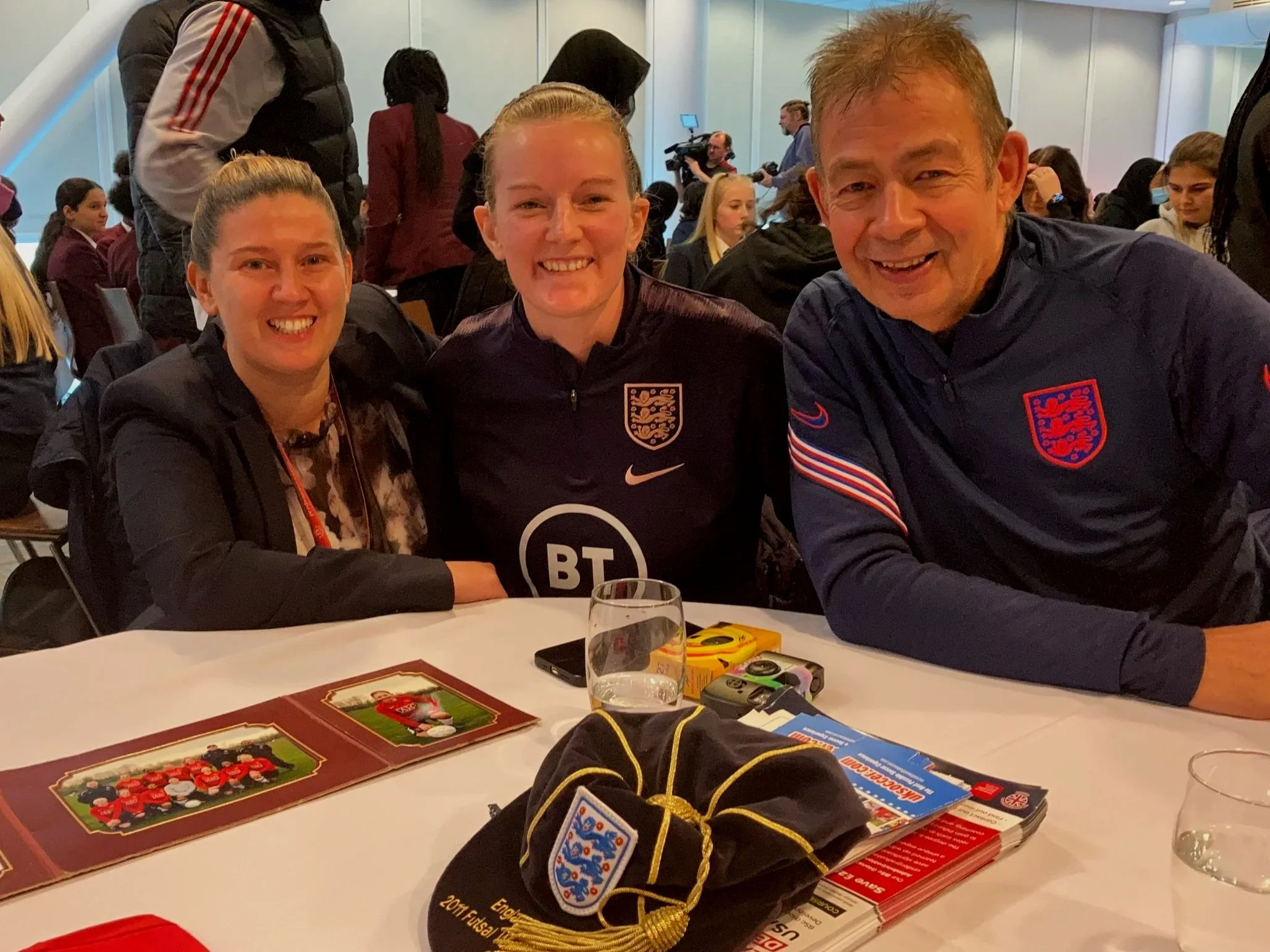 Group pose with the historic and official England Cap, photography and memorabilia is on the table in front of them also