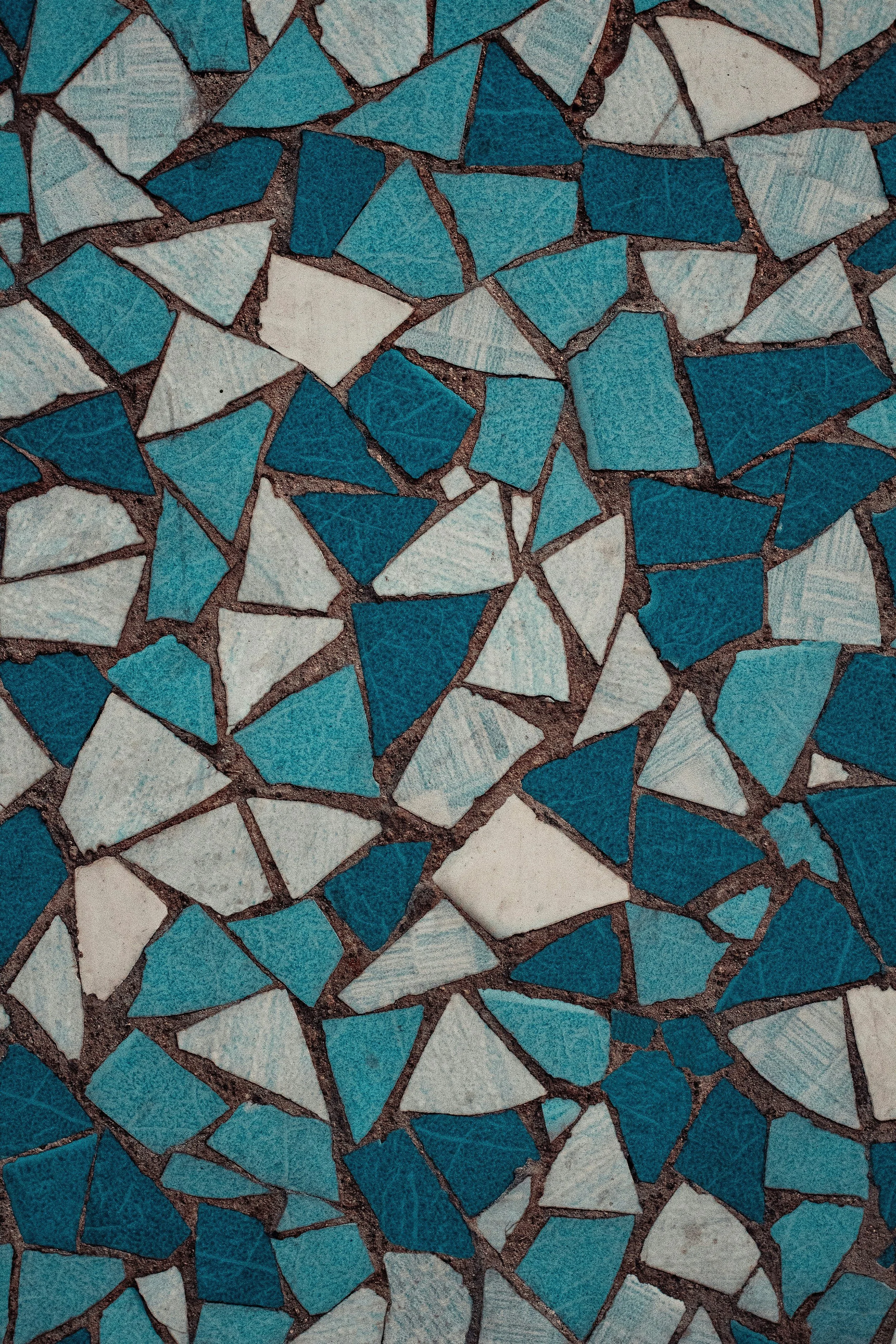 Close-up of turquoise and white mosaic tiles with dark grout lines.