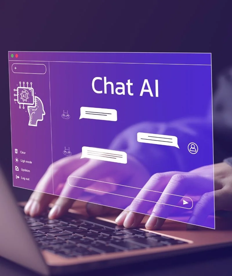 A person typing on a laptop with a transparent, futuristic chat AI interface overlay showing chat bubbles and icons.