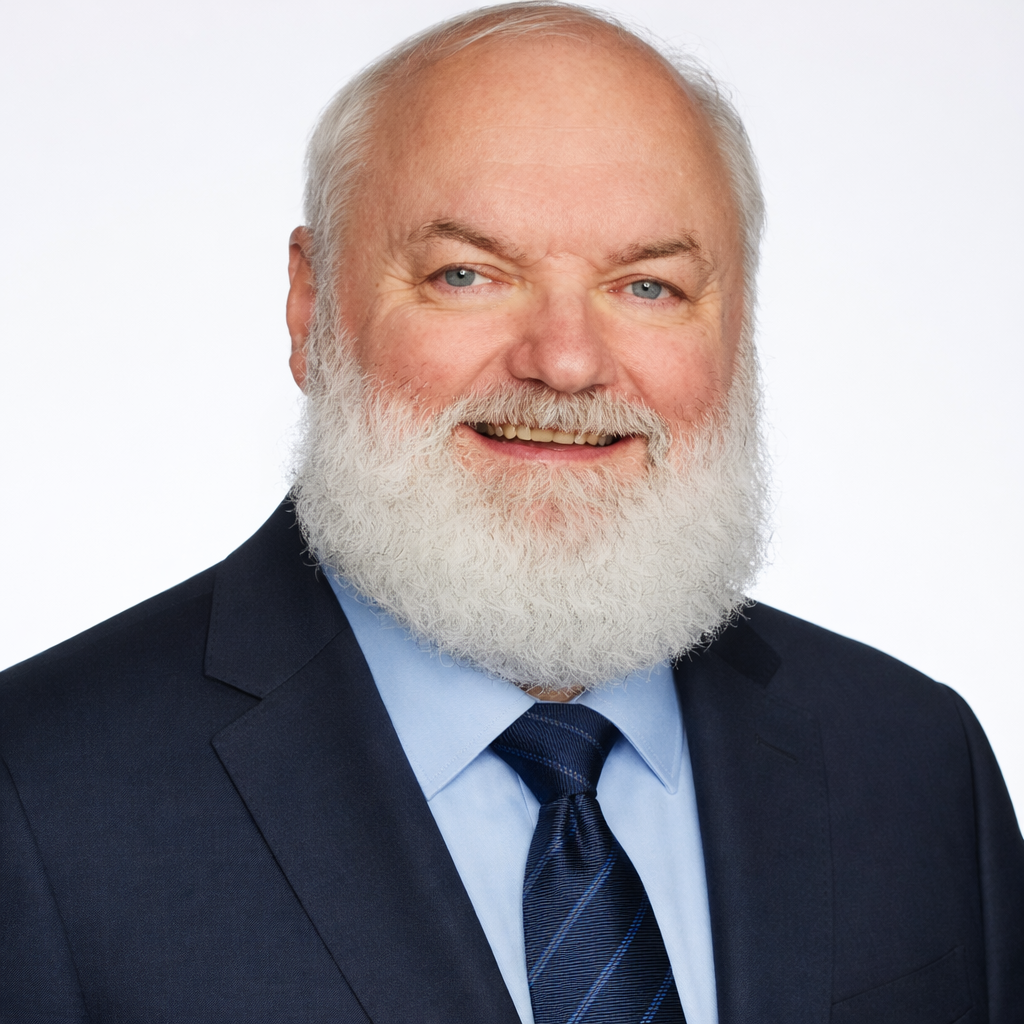 Dave Davis - Portrait of an elderly man with a white beard and light blue eyes, dressed in a dark blue suit, light blue shirt, and a dark blue tie, smiling against a plain white background.