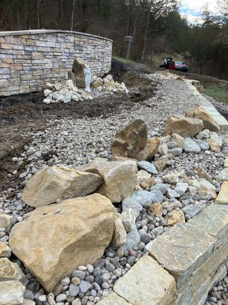 Boulders carefully placed to look like they have always been here