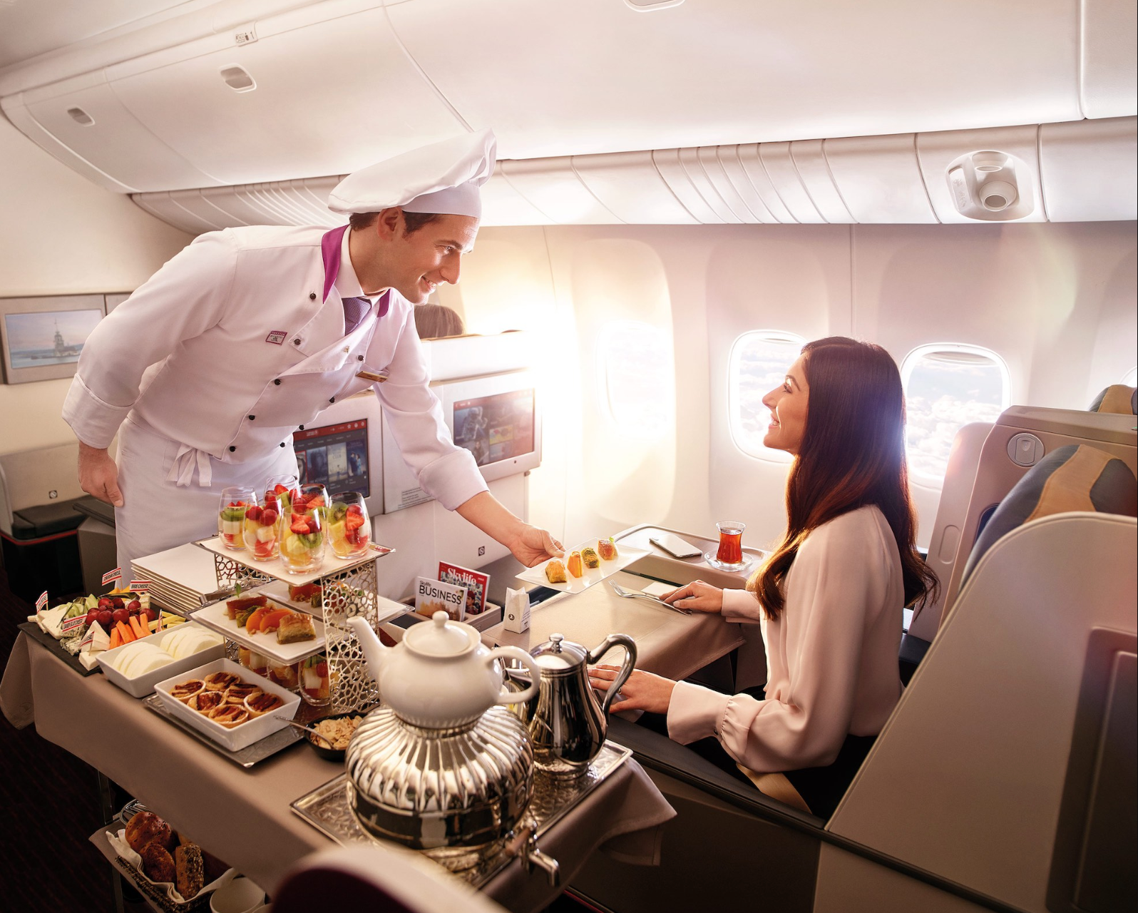 The Turkish Airlines business class meal service, featuring an onboard chef bringing dessert trays through the cabin