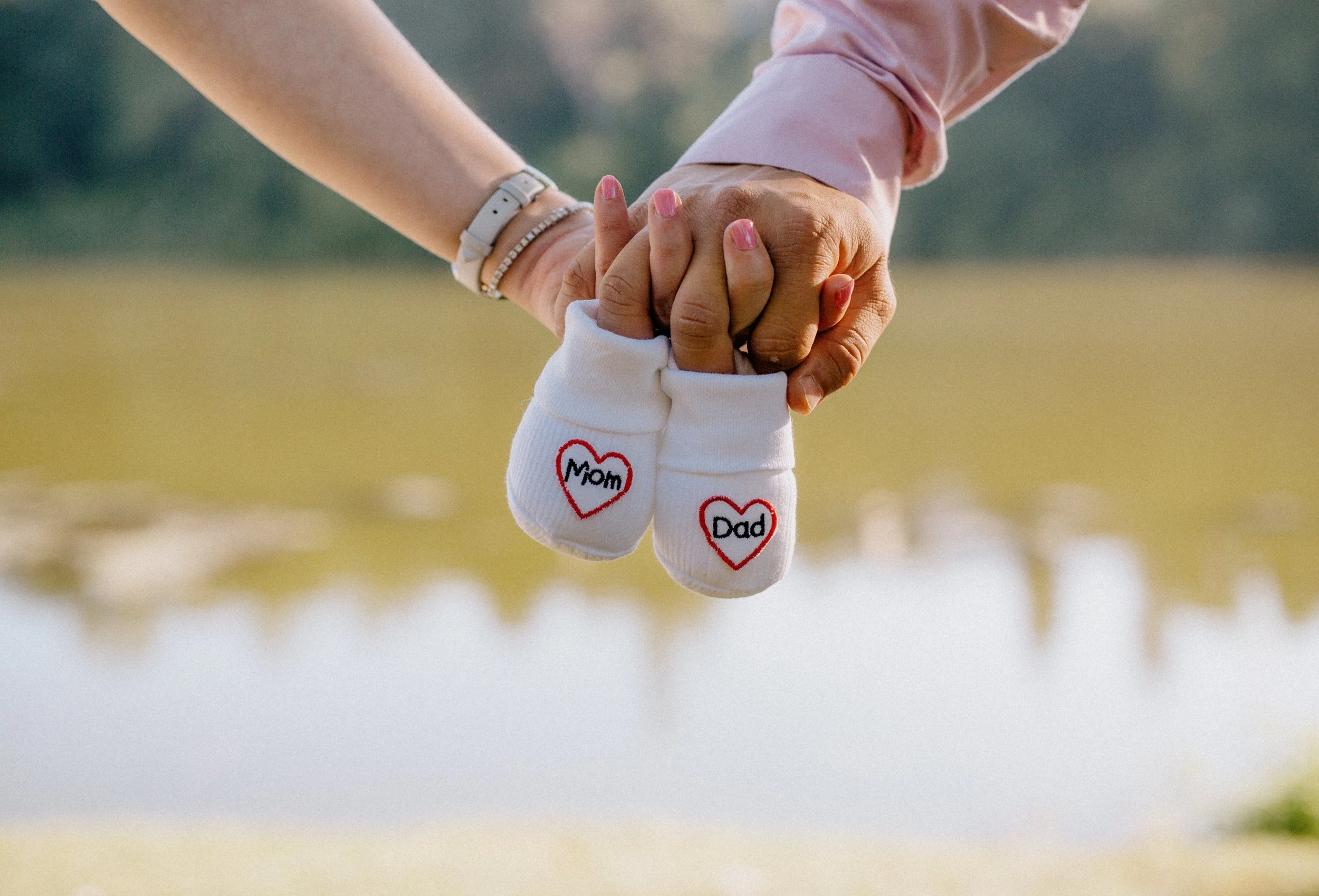 ProspectMidwife Patients holding their hands and holding small baby socks in oklahoma