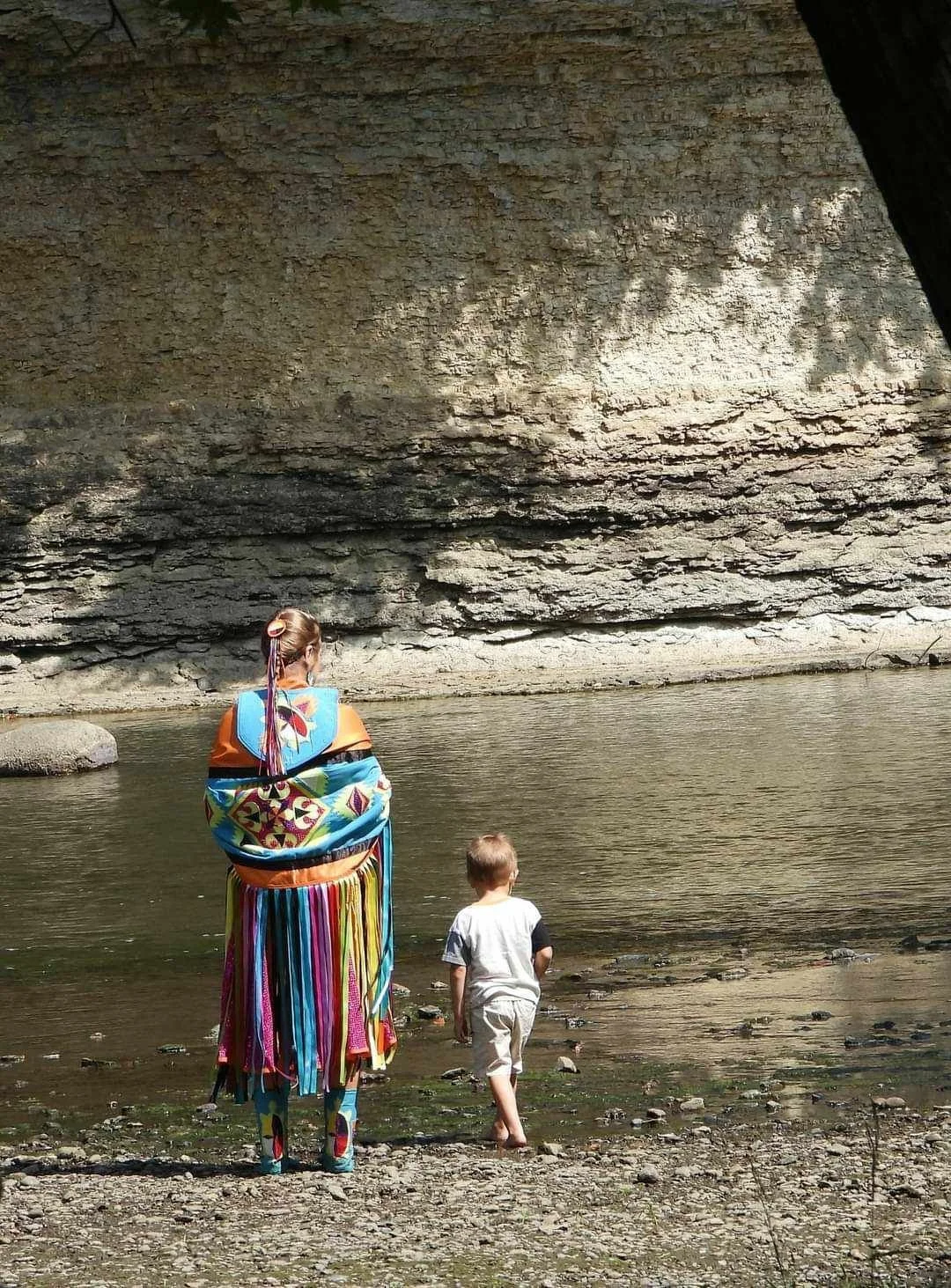 Kayla Rudd walking across the Mississinewa with her son admiring the pillars