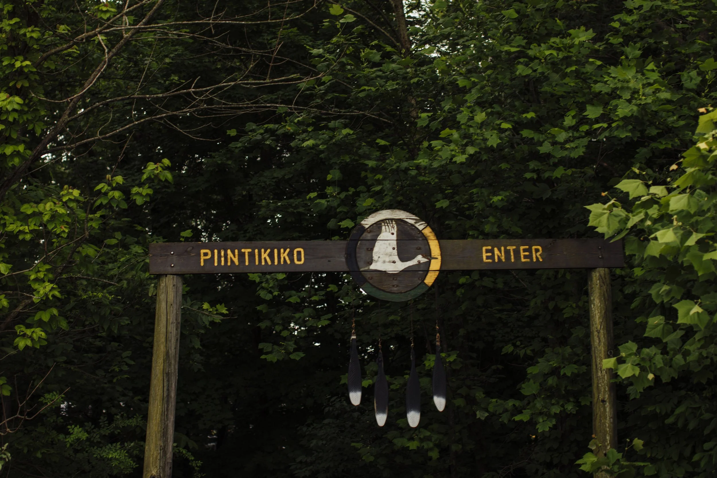 Wooden entrance with writing bilingual in Miami and English marked “piintikiko/enter”