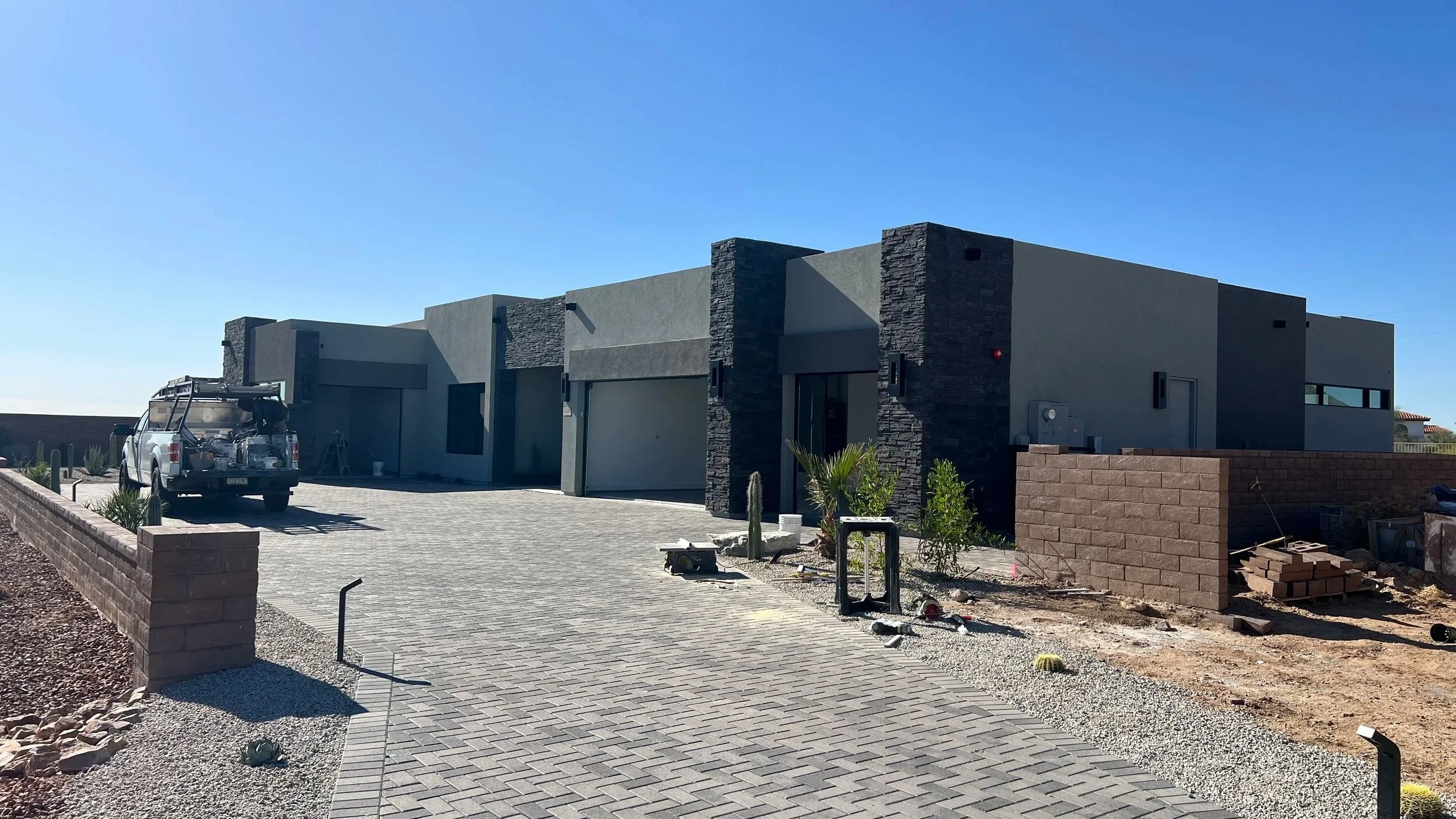 Modern house under construction with landscaping and materials nearby, captured during a new construction walkthrough by Nova Inspections - Tucson Home Inspector.