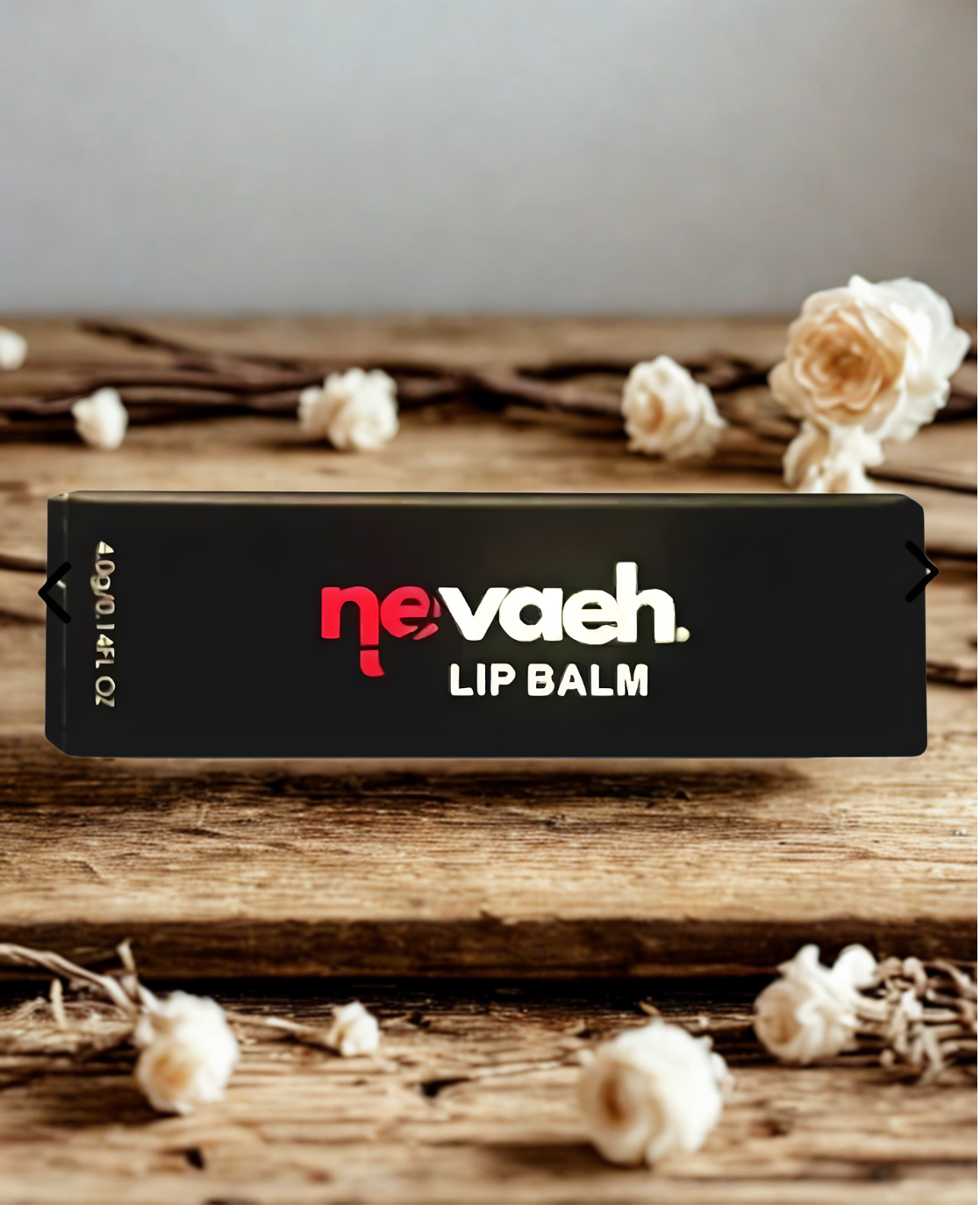 Nevaeh lip balm box on a wooden surface surrounded by pops of popcorn and decorative flowers.