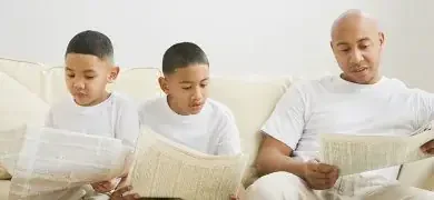 padre lee el periodico y sus hijos hacen lo mismo en un aprendizaje por modelado