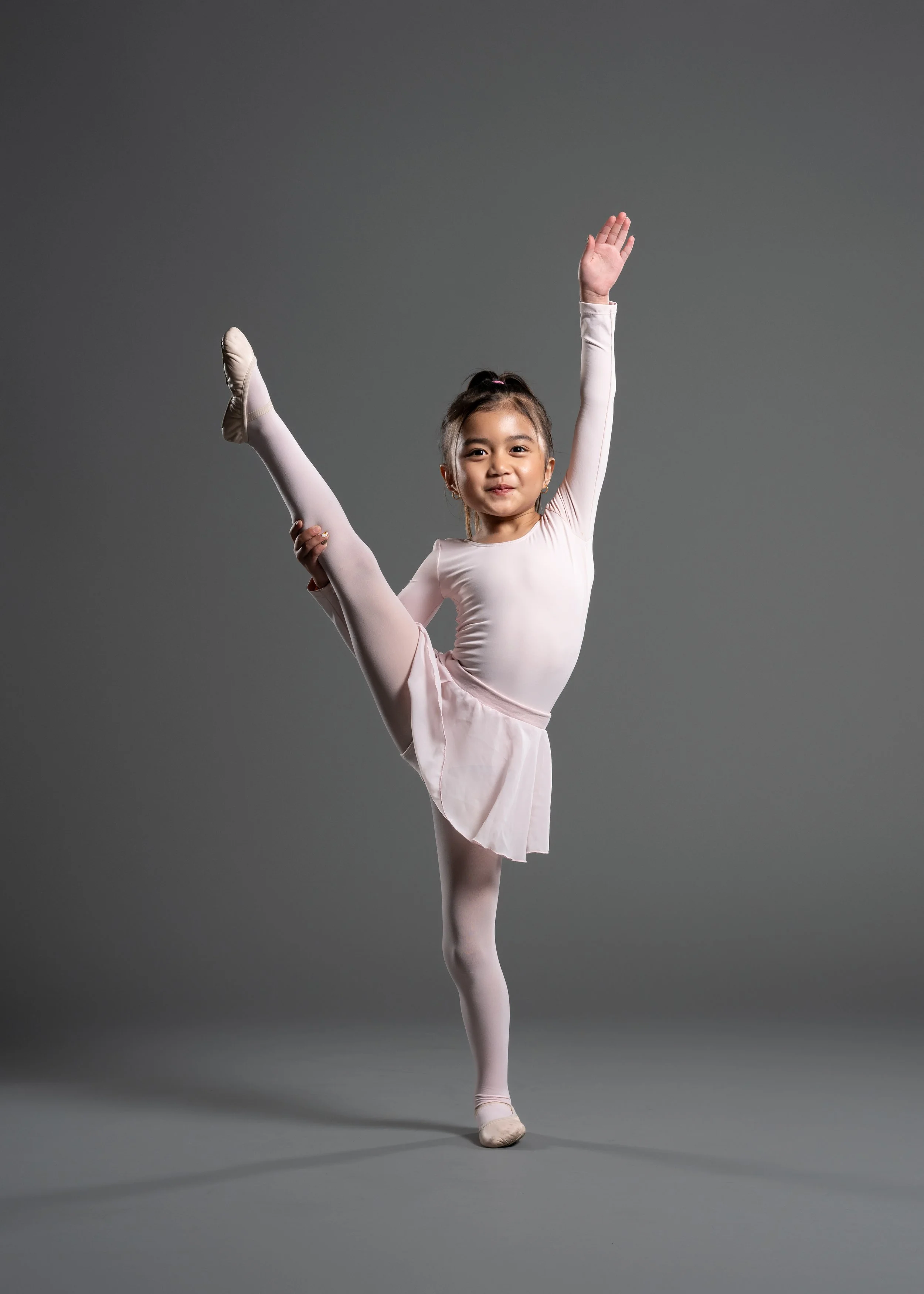 Little ballet dancer doing a leg hold