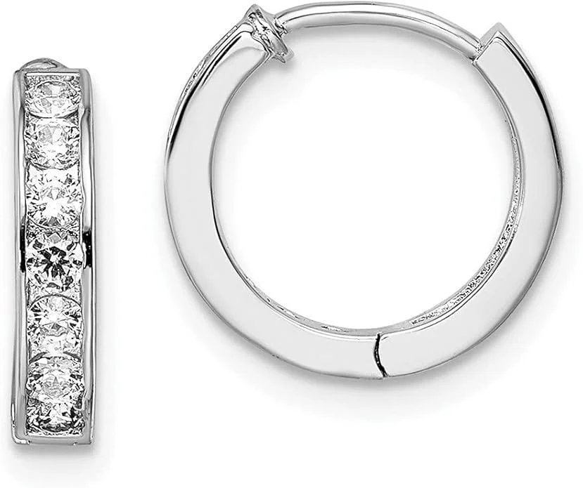 Close-up of a pair of silver hoop earrings, one with embedded clear gemstones.