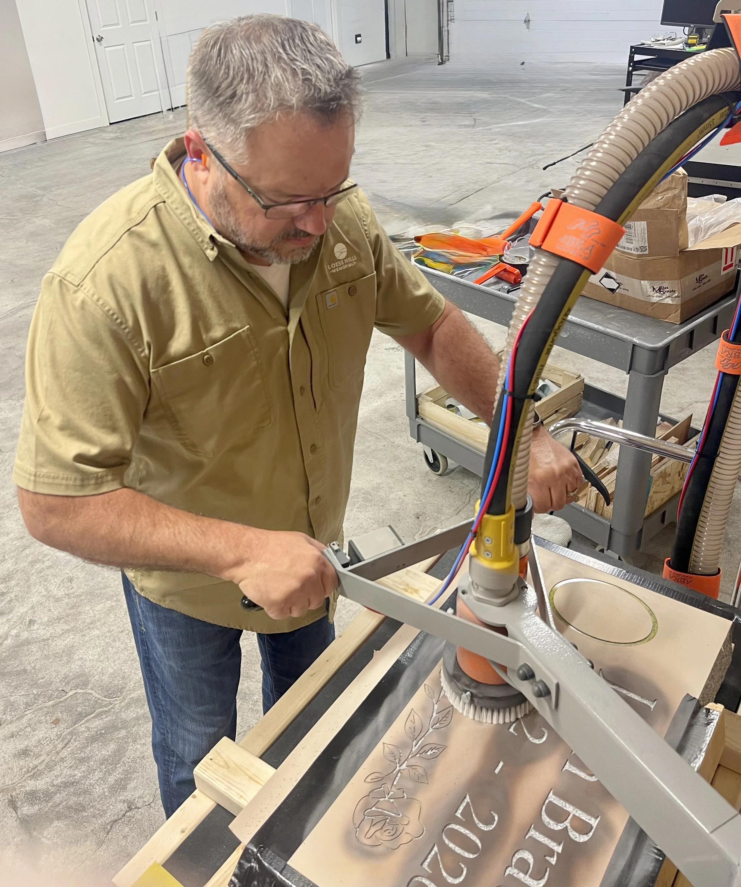 Personally sandblasting a memorial in our Missouri Valley shop, where traditional craftsmanship and attention to detail come together to create a lasting tribute