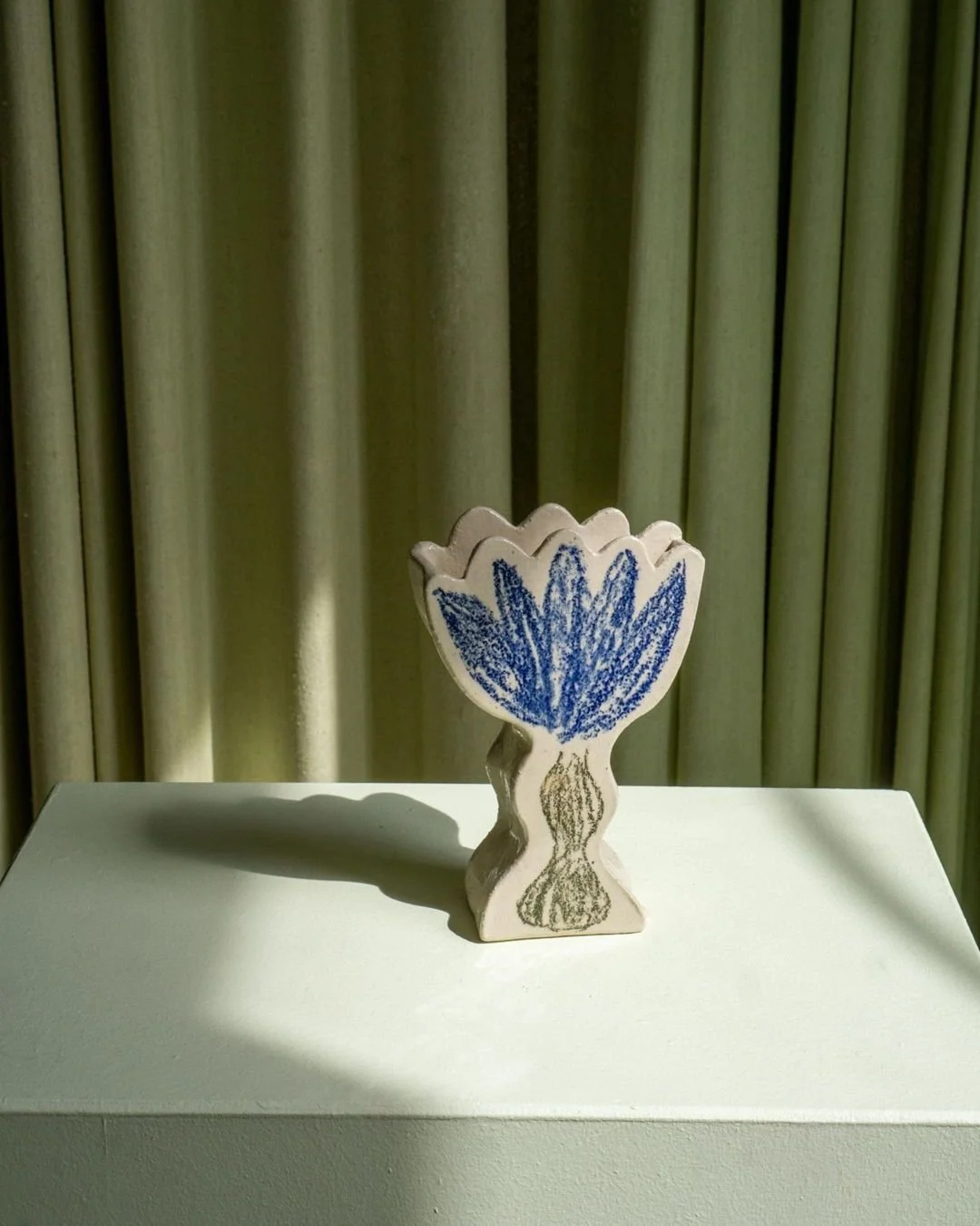 Beautiful Wallflower Blue Vase, part of our selection of ceramic pieces created by Charlotta Munsterhjelm. Available now at craftersoftoday.com.

Hand built in stoneware in Helsinki and finished with painted blue petals on a natural clay surface. Its