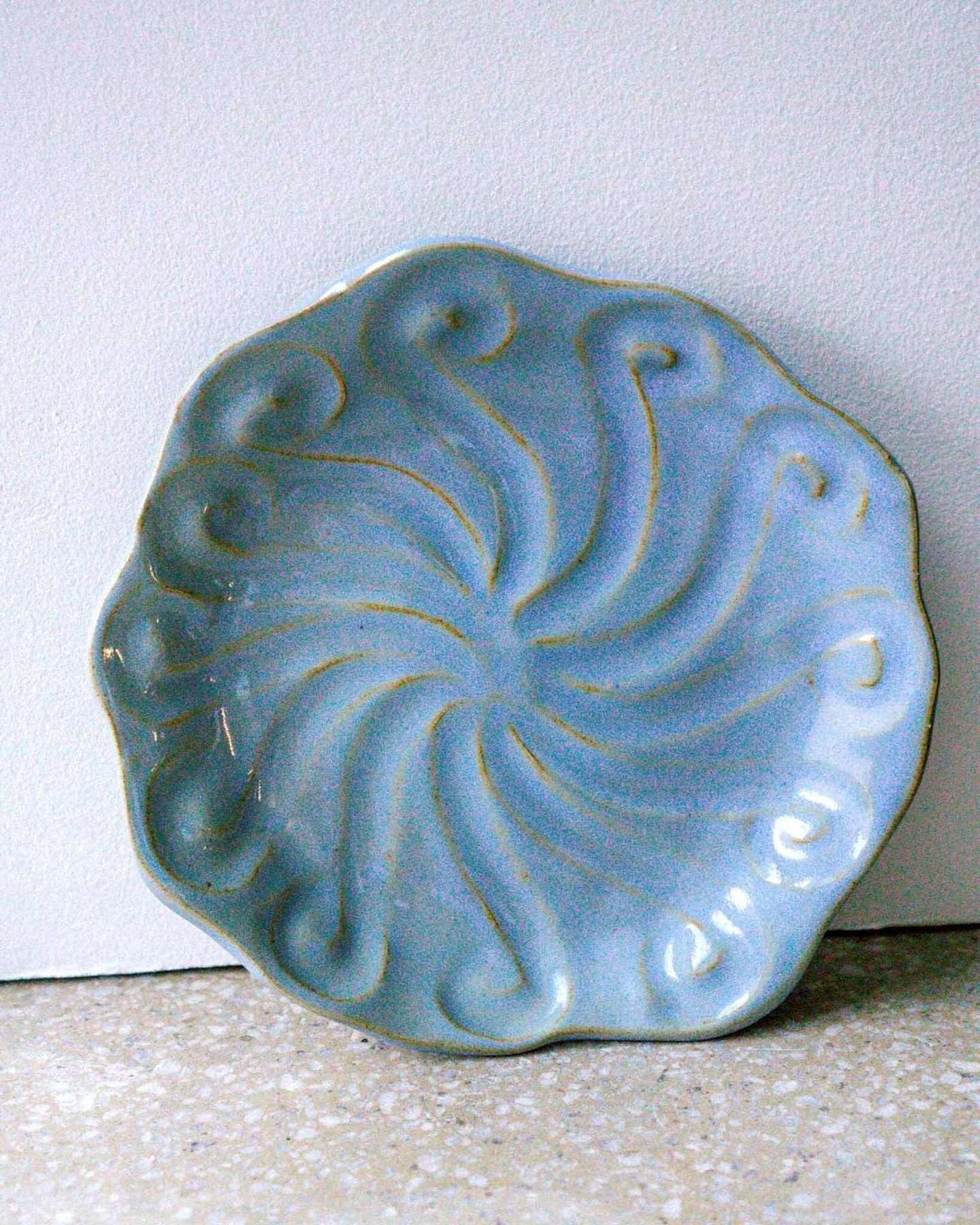 Stoneware Blue Plate 

Hand built in stoneware, the Striped Blue Plate is finished with a clear, food safe glaze that brings out its soft blue surface. Its gentle shape and calm colour reflect Charlotta Munsterhjelm&rsquo;s thoughtful approach to cla