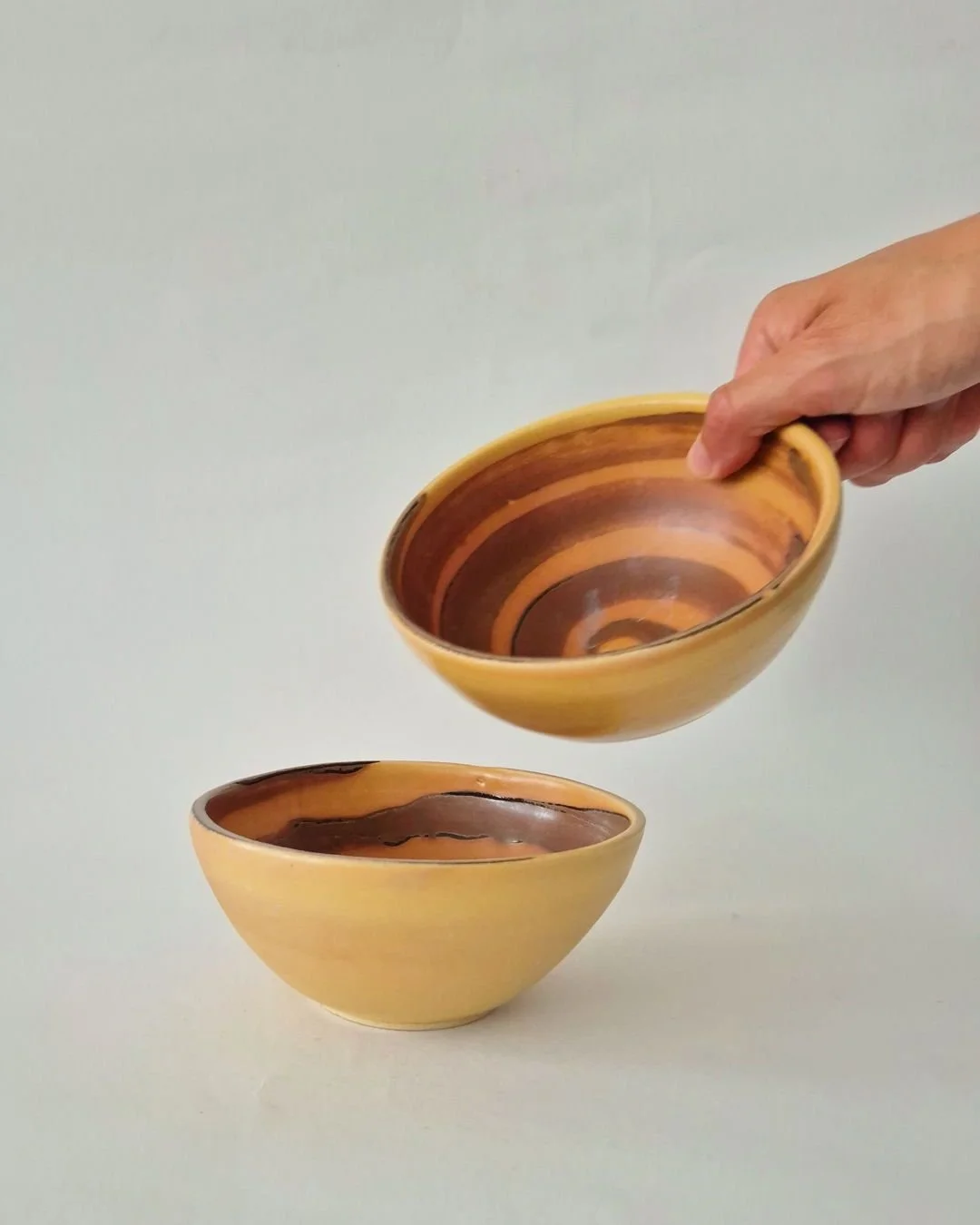 Spiral Bowl

Hand-thrown in stoneware, this Spiral bowl is made by Marjorie Broudieu in Amsterdam. Finished in a warm Dulce de leche glaze, the piece holds a gentle spiral, balancing volume with a tactile, compact presence. The form is informed by Br