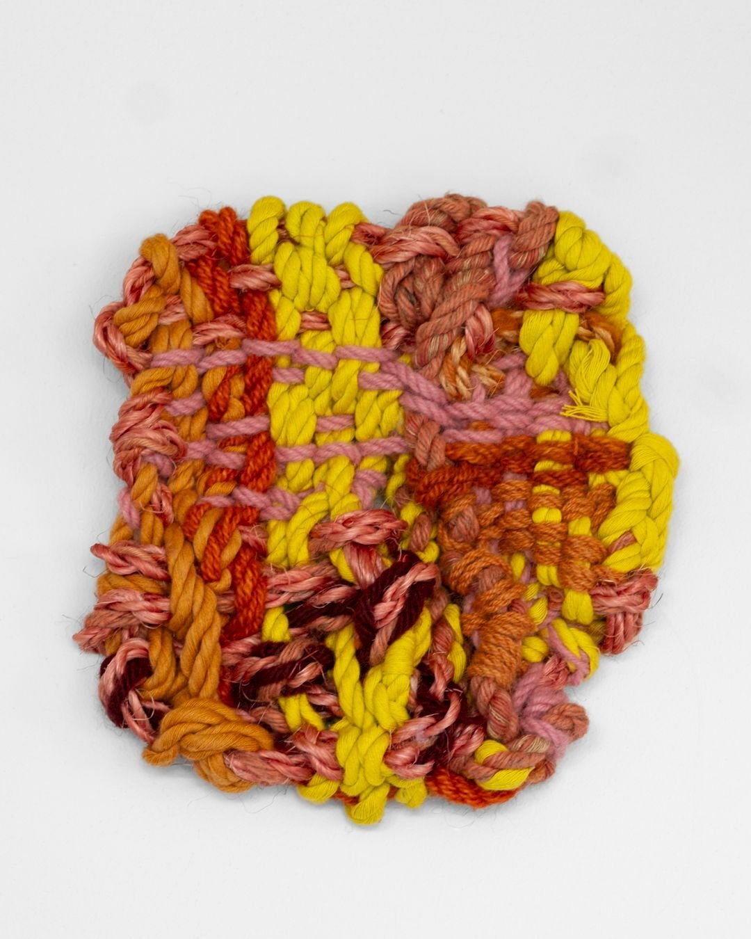 Unit, a handwoven textile piece by Sofie Karlsson, is crafted through a meticulous combination of weaving and ropemaking using cotton, jute, hemp, sisal, and wool. The work explores colour and structure as a tactile language, drawing deeply from dome