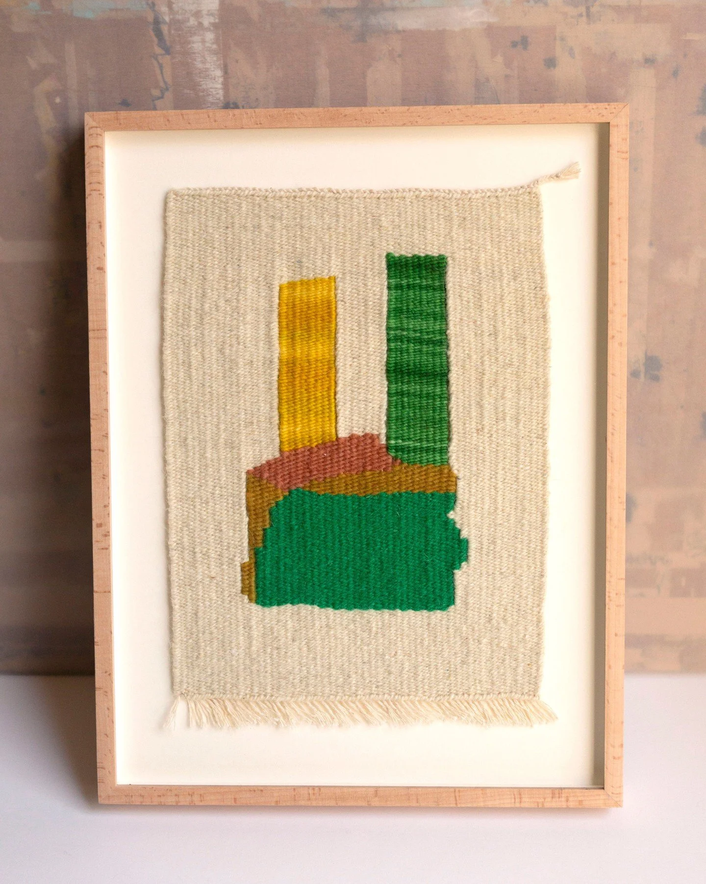 Series Totems 

This series brings together three handwoven pieces by Isabel R&iacute;os, made in Barcelona. Using naturally dyed yarns and fibers gathered through different journeys, each composition unfolds vertically through stacked forms, where f
