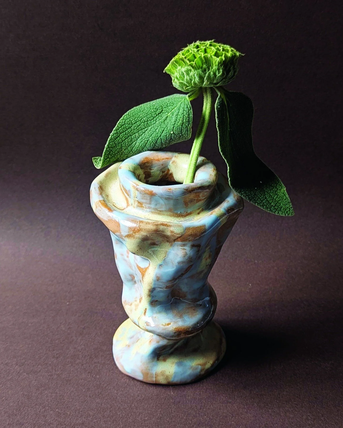 Vase No. 3 Crater

Hand built in warm brown stoneware using the coil technique by Elsa Claesen in Santa Catarina, Portugal, Vase No. 3 Crater explores sculptural form through its fluid, twisted silhouette and organic movement. Finished with a marbled