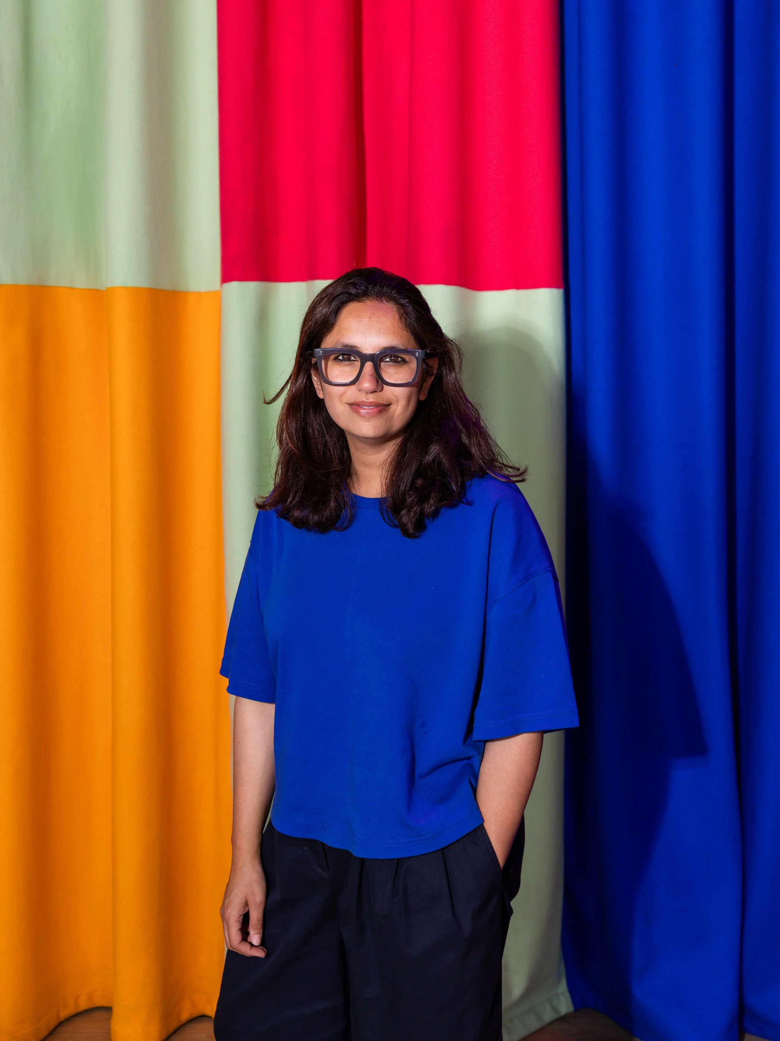 Kangan Arora in her London studio surrounded by woven textiles, colour studies, and geometric compositions