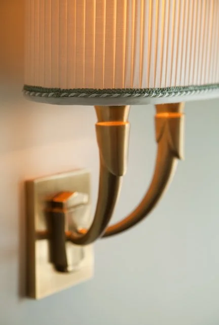 Solid brass sconce with 2 arms and a custom pleated shade with green trim