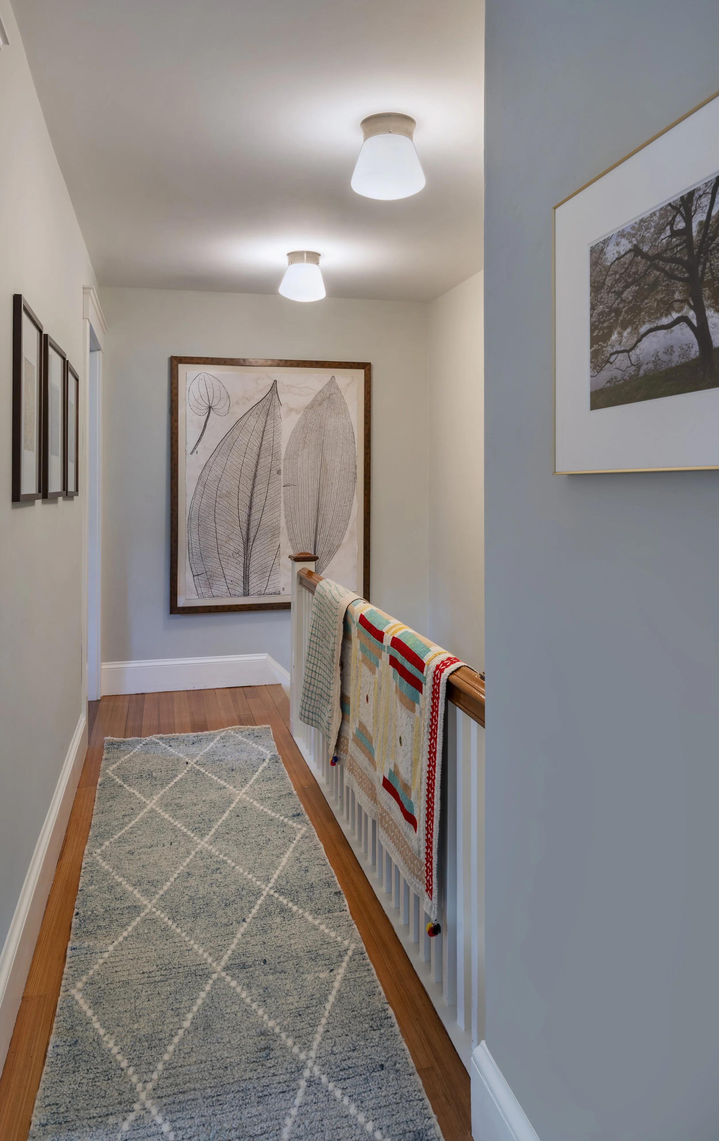 Cambridge hallway vintage textile runner with framed art by AbbeyK Interior Design