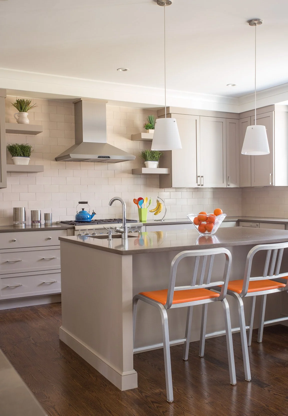 Kitchen in the Needham new construction home with taupe shaker cabinets and a lighter ceramic subway tile backsplash for contrast. 