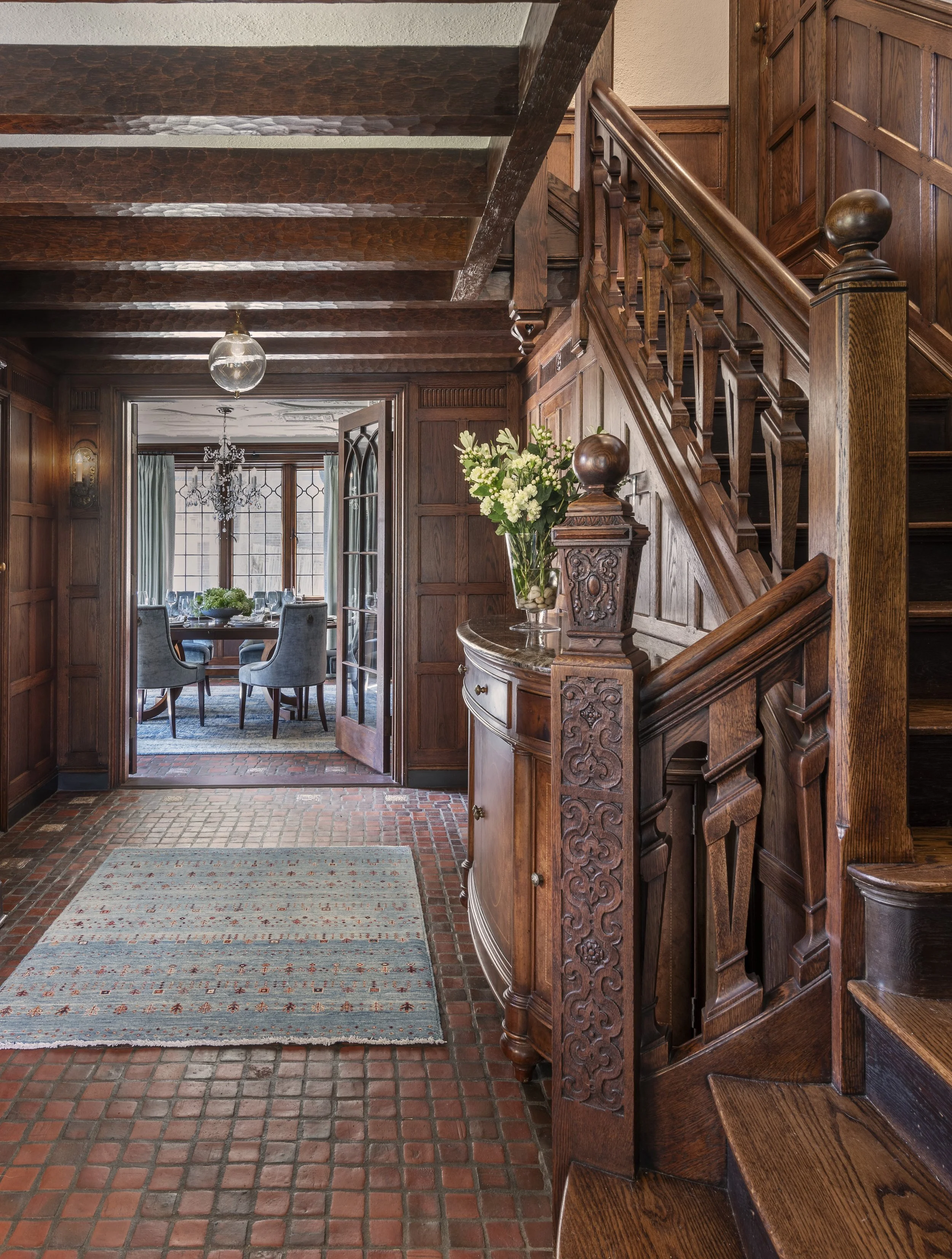 chestnut-hill-brookline-ma-tudor-high-end-decorating-stair-hall-carved-oak-staircase-modern-runner-dining-view-abbeyk.jpg