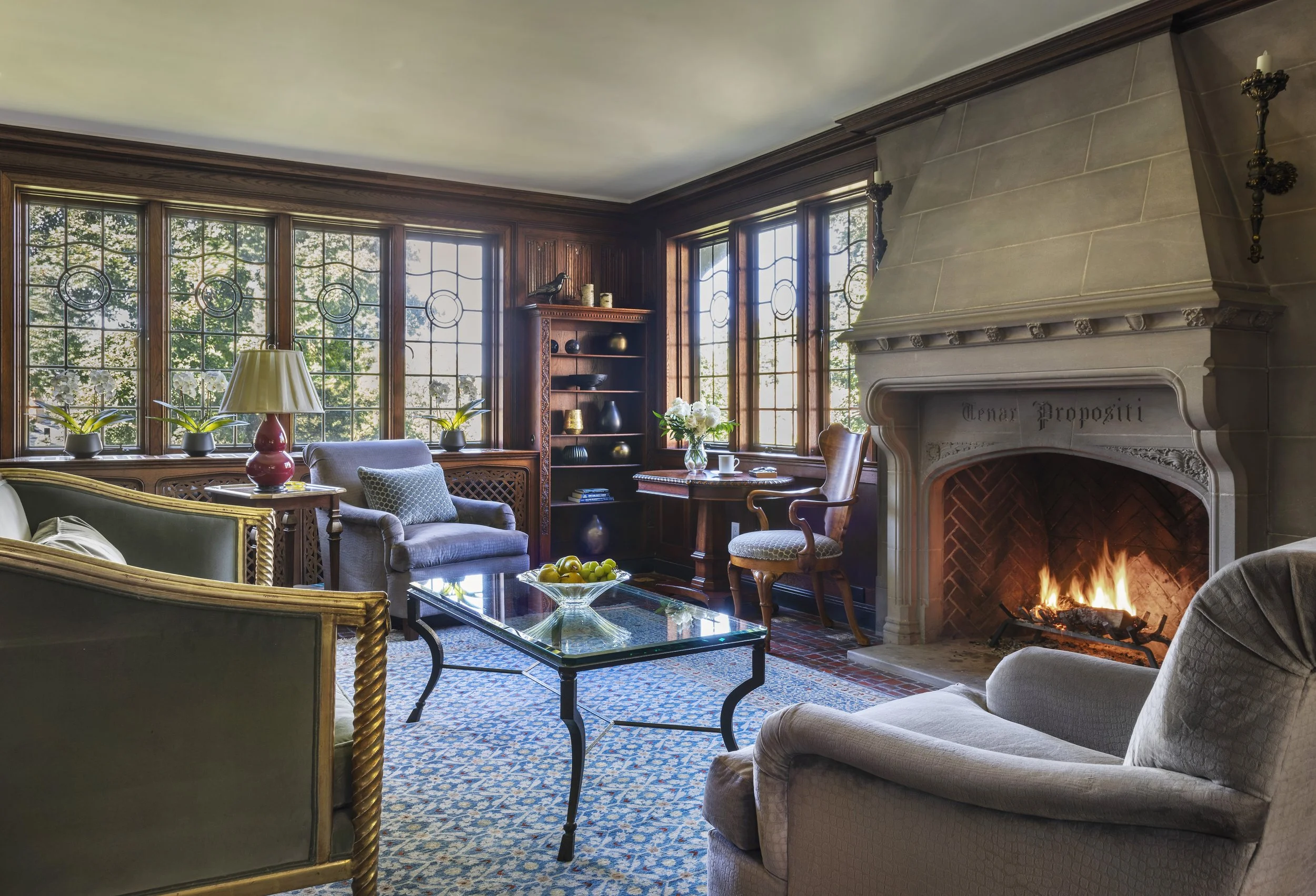 chestnut-hill-brookline-ma-tudor-high-end-decorating-living-room-limestone-fireplace-leaded-glass-built-ins-gilded-sofa-abbeyk.jpg