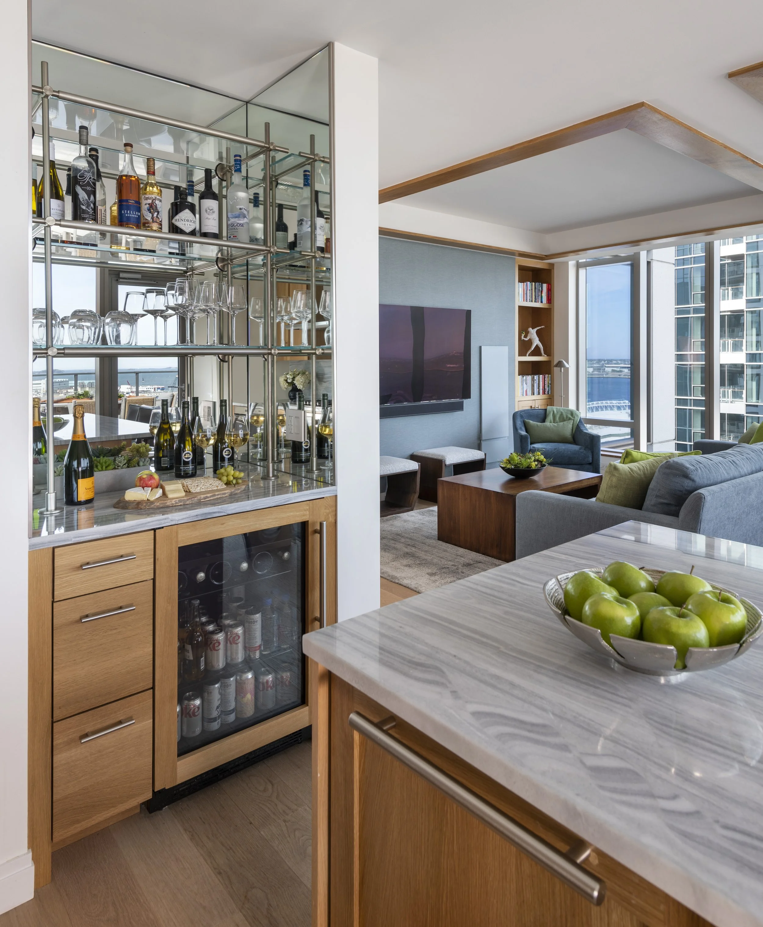 Seaport kitchen with custom mirrored bar, marble counter. Mirrors reflect the view.