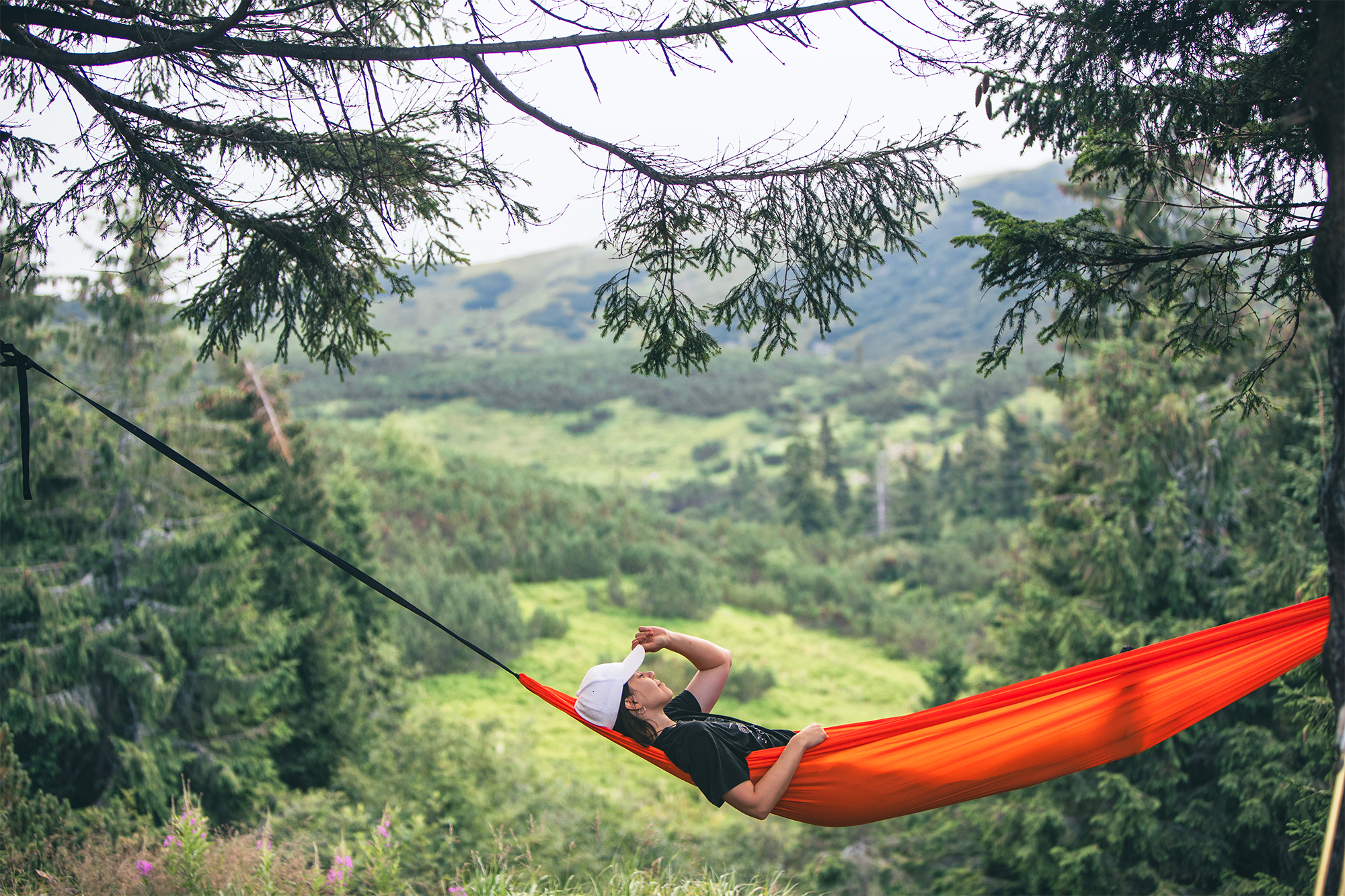 happy-woman-on-hammock-mountains-on-background-2025-03-09-20-31-08-utc copy.webp