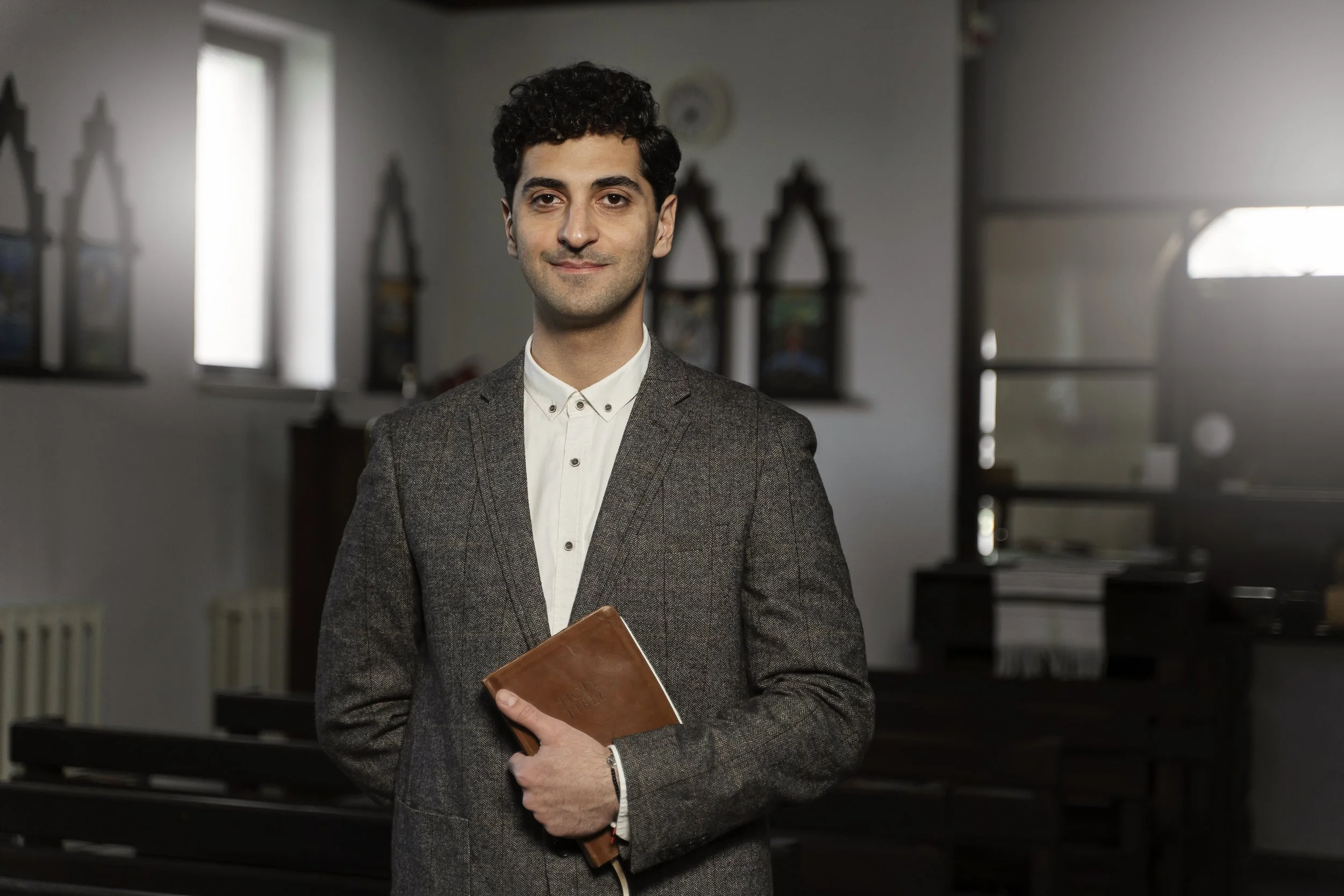 medium-shot-young-pastor-holding-bible.jpg