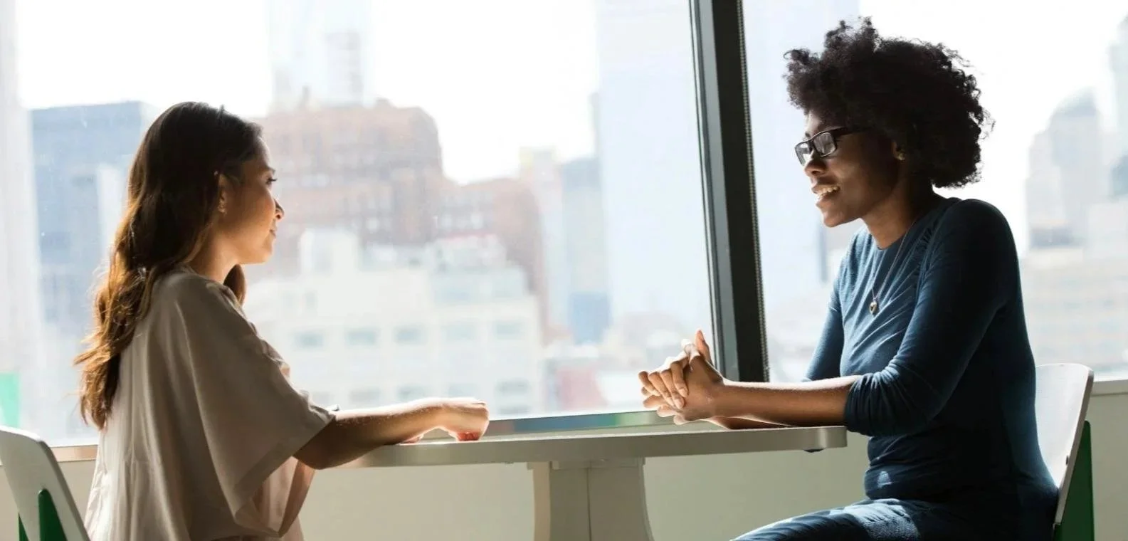 Two women engaged in therapy / counselling. Culturally diverse and non- judgmental.