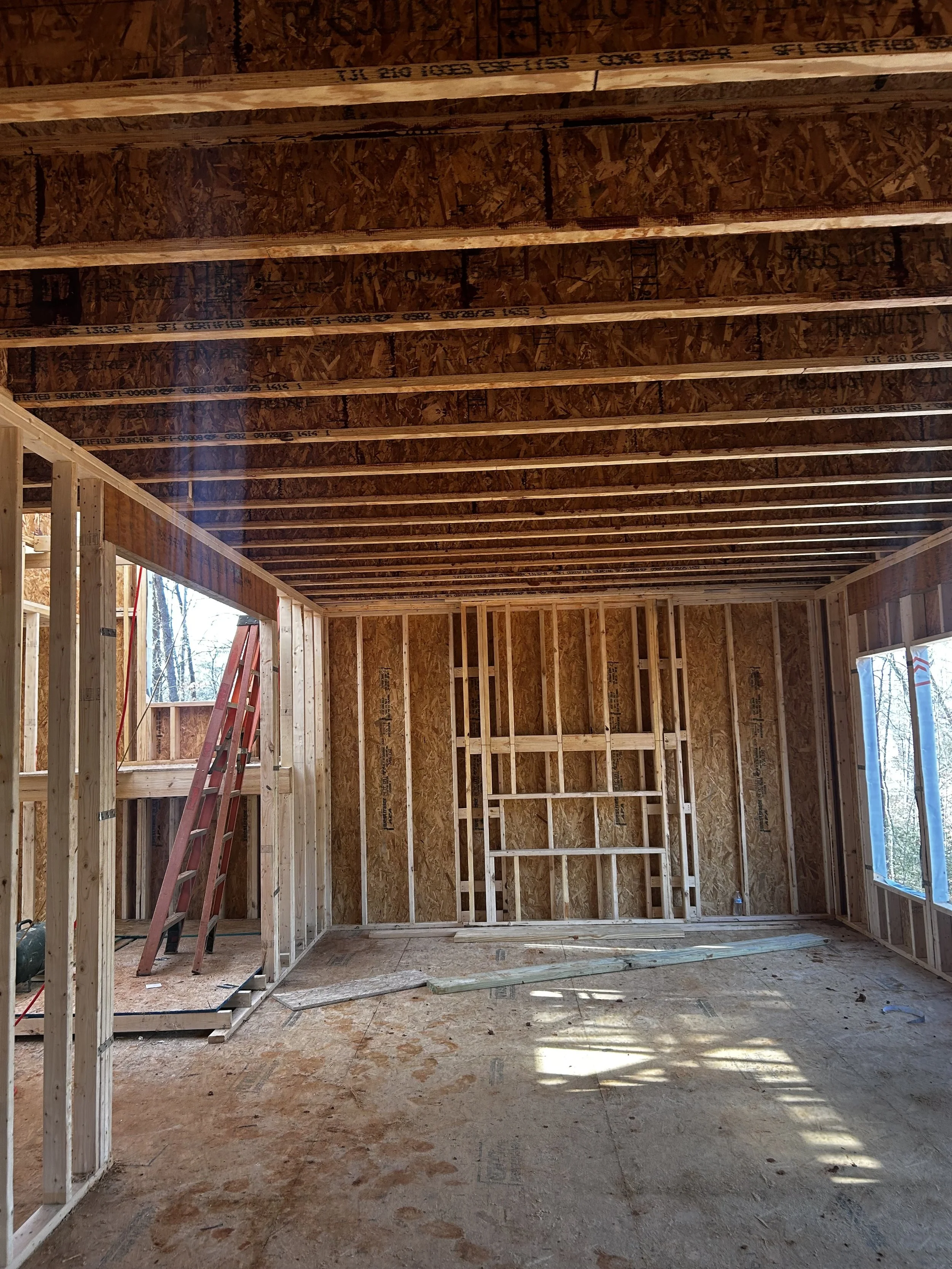 Interior framing of the R&W Homes Mason model in Spotsylvania, VA showing engineered floor joists, OSB subfloor, and interior wall framing during new home construction