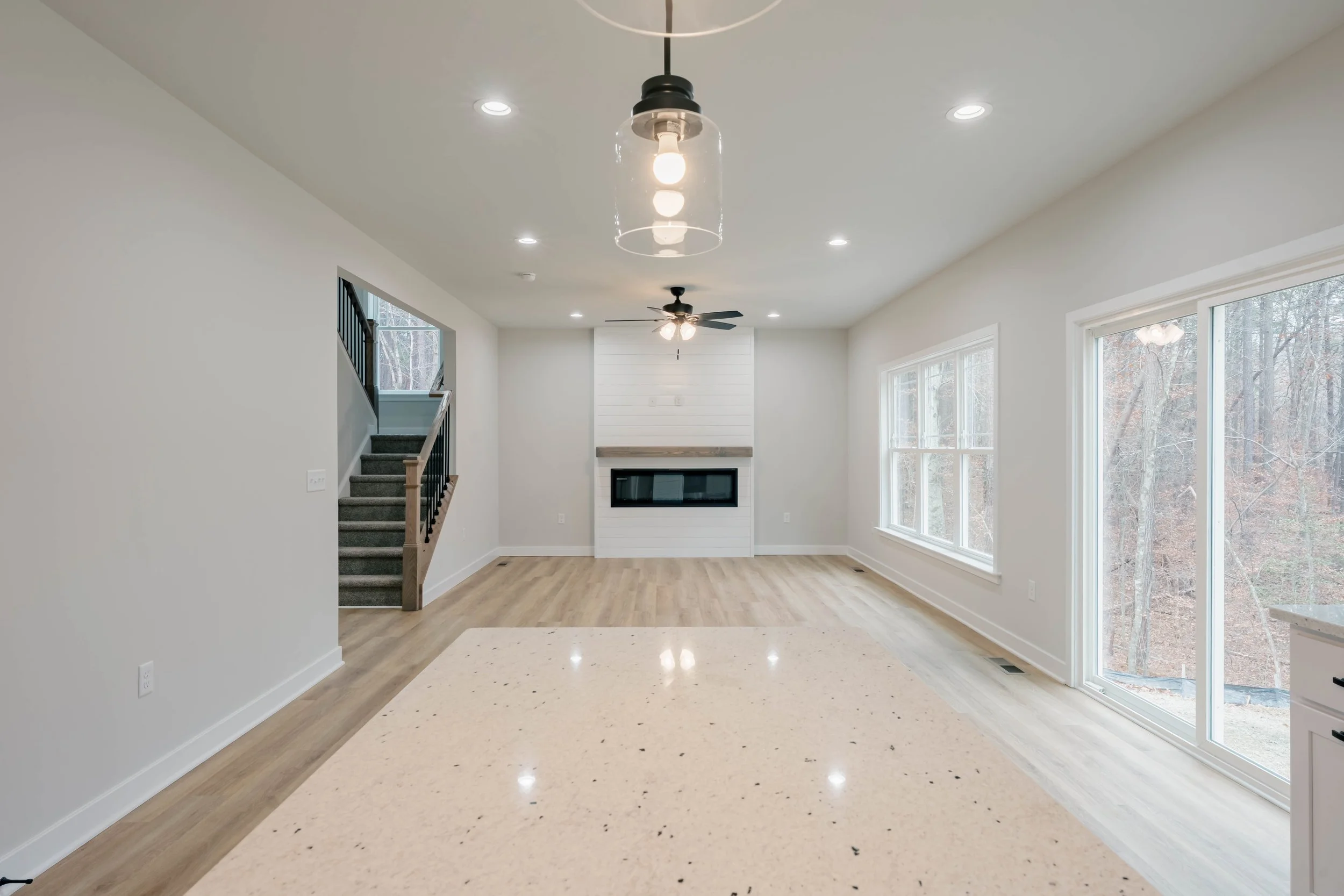 Custom living room in Fredericksburg, VA, with vaulted ceilings, energy-efficient windows, and natural gas fireplace by boutique builder R&W Homes.