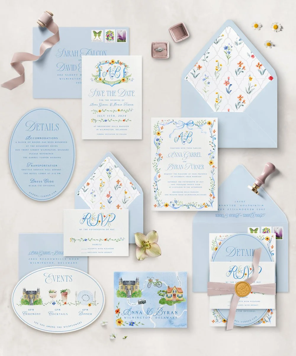 Custom Luxury wedding invitation suite with floral designs, RSVP card, details card, envelope, and decorative items such as a pink ribbon, ring box, and flowers. Whimsical custom stationery.