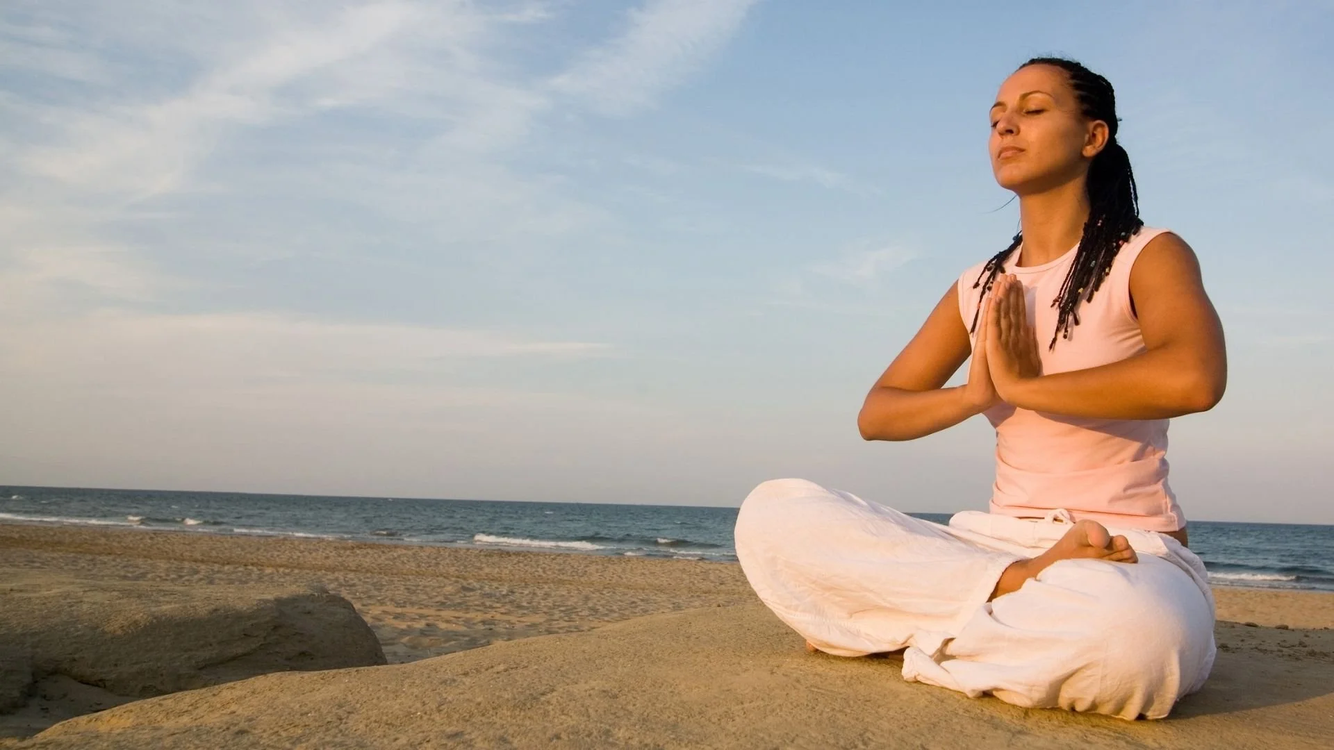 woman on the beach practicing deep breathing and other somatic techniques for trauma healing