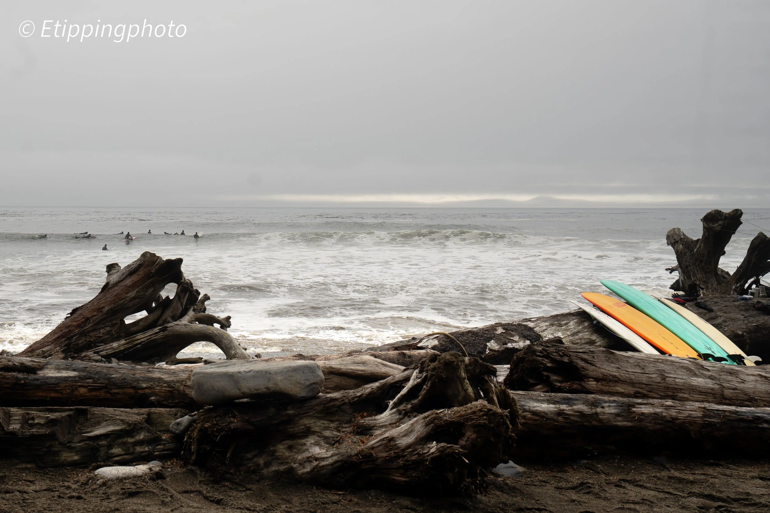 Surfers and Driftwood — Sombrio Beach · 35 mm · 1/125 s · f/6.3 · ISO 125