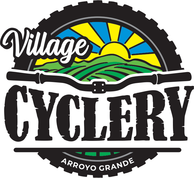 Logo for Village Cyclery featuring a sunrise over green hills, with the text 'Village Cyclery' and 'Arroyo Grande'.