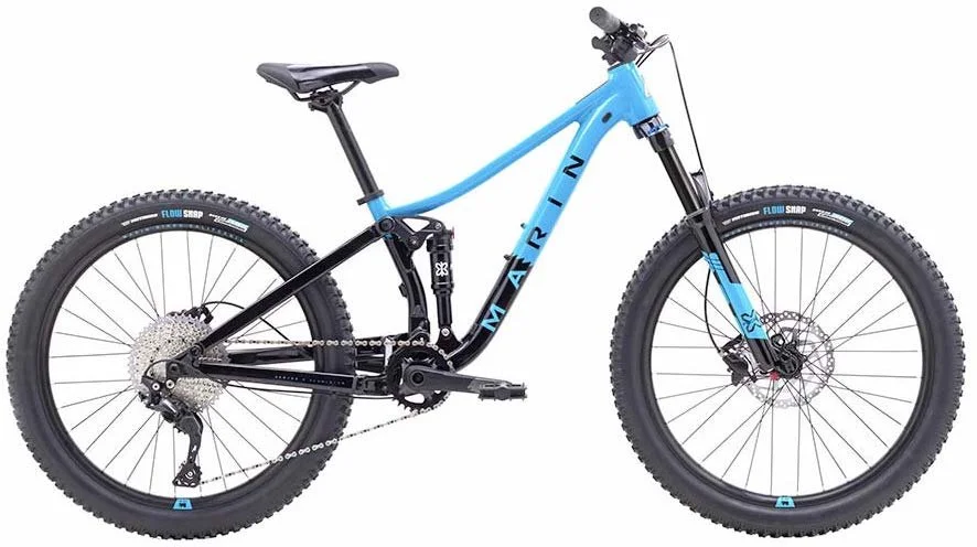 Blue and black mountain bicycle with thick tires and front suspension.