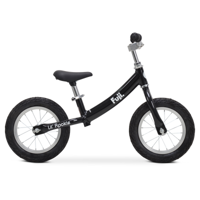 Children's black and gray balance bike with training wheels and the word 'Lil Rookie' on the frame