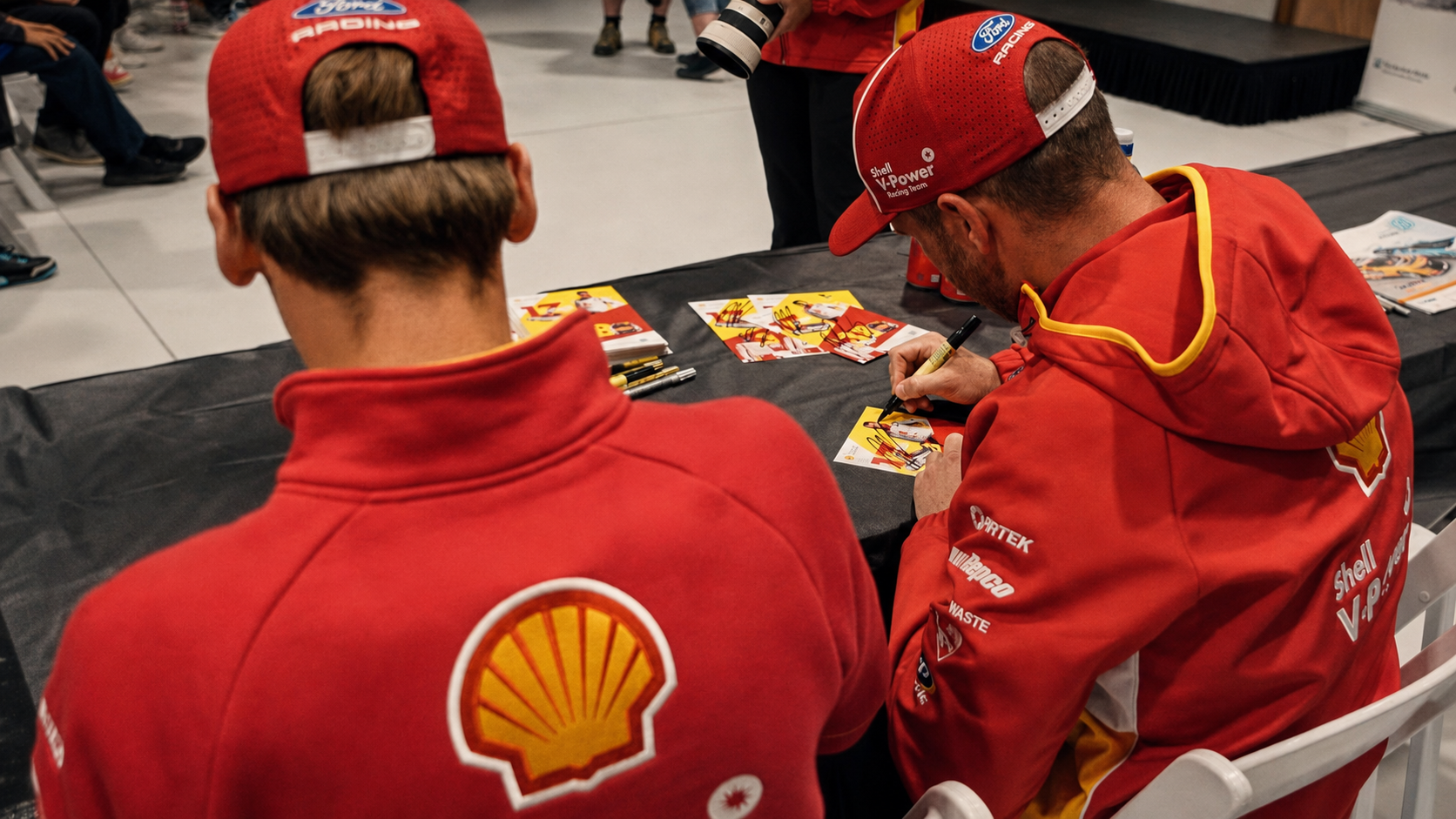 Two Supercars drivers signing autographs at the Rosiez Collision Centre event