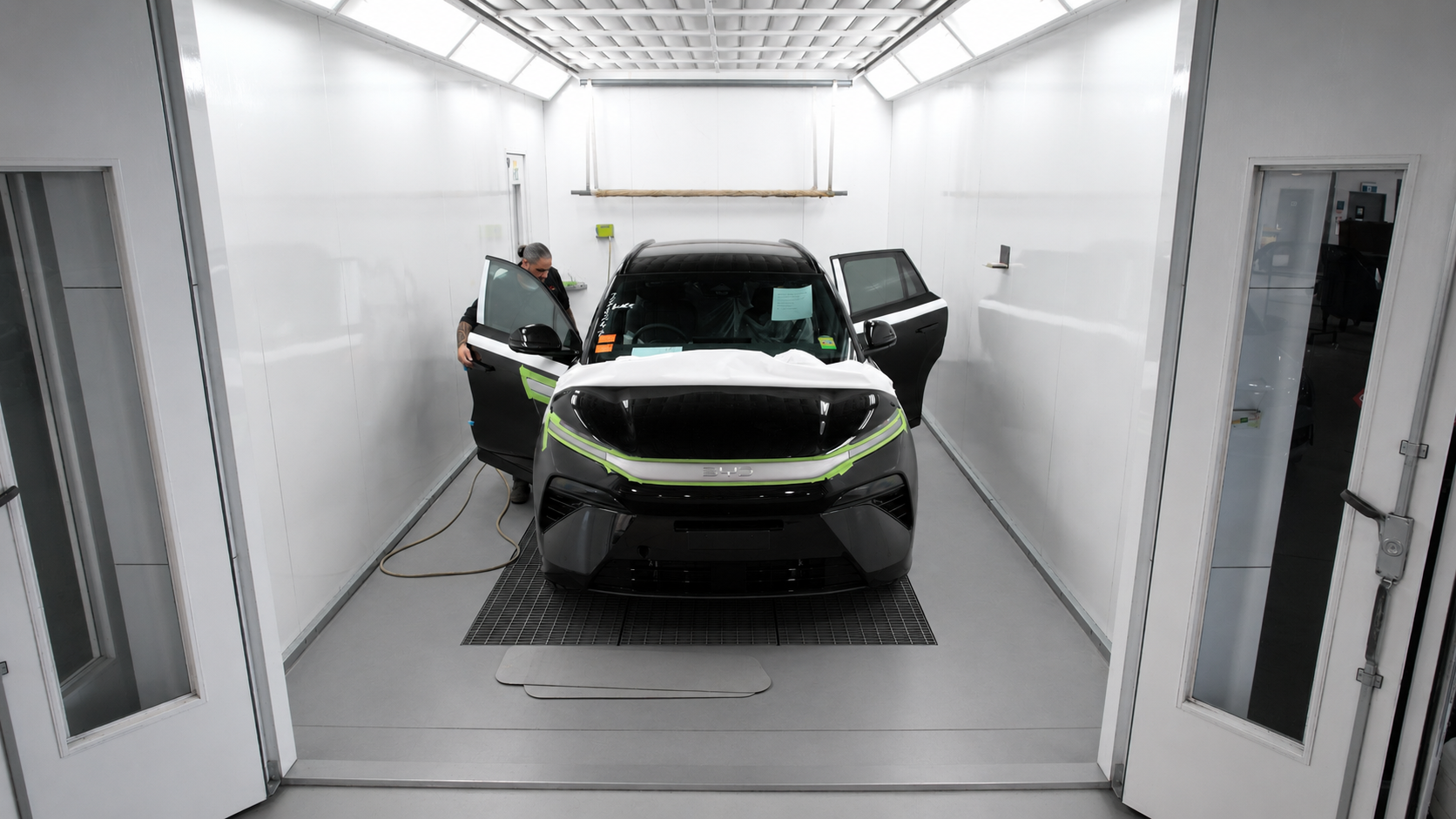 Vehicle being worked on inside the West Hamilton Auto Refinishers paint booth