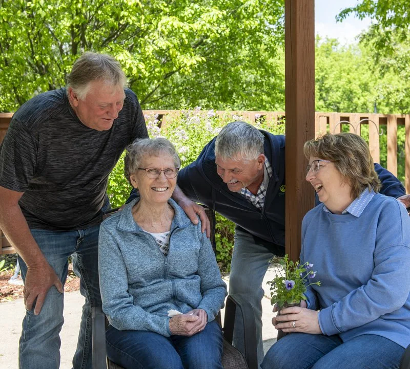 Family visiting parent in Riverhaven Memory Support at St. John's Skilled Nursing Home in Springfield, Minnesota