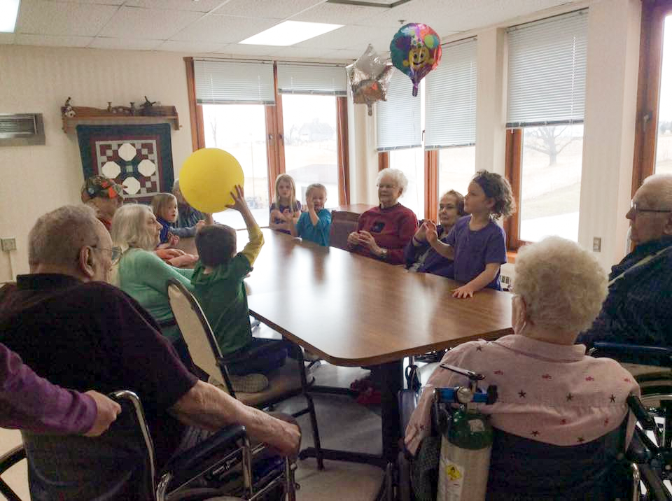 Intergenerational care between Grandkids daycare children and residents of St. John's Lutheran Home, Springfield MN